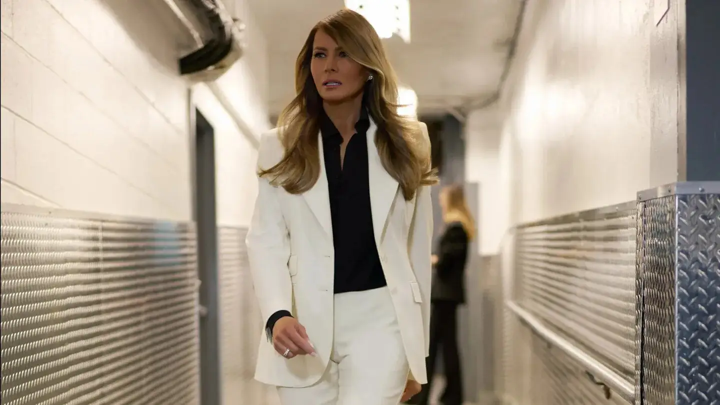 Melania Trump in a white suit and black shirt
