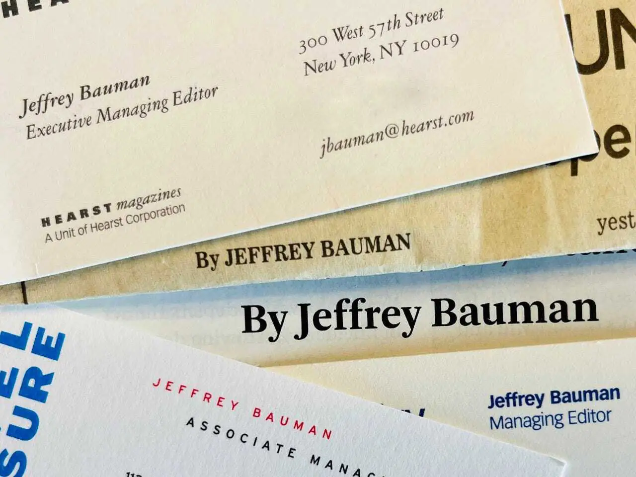 Pile of Jeffrey Bauman business cards and bylines