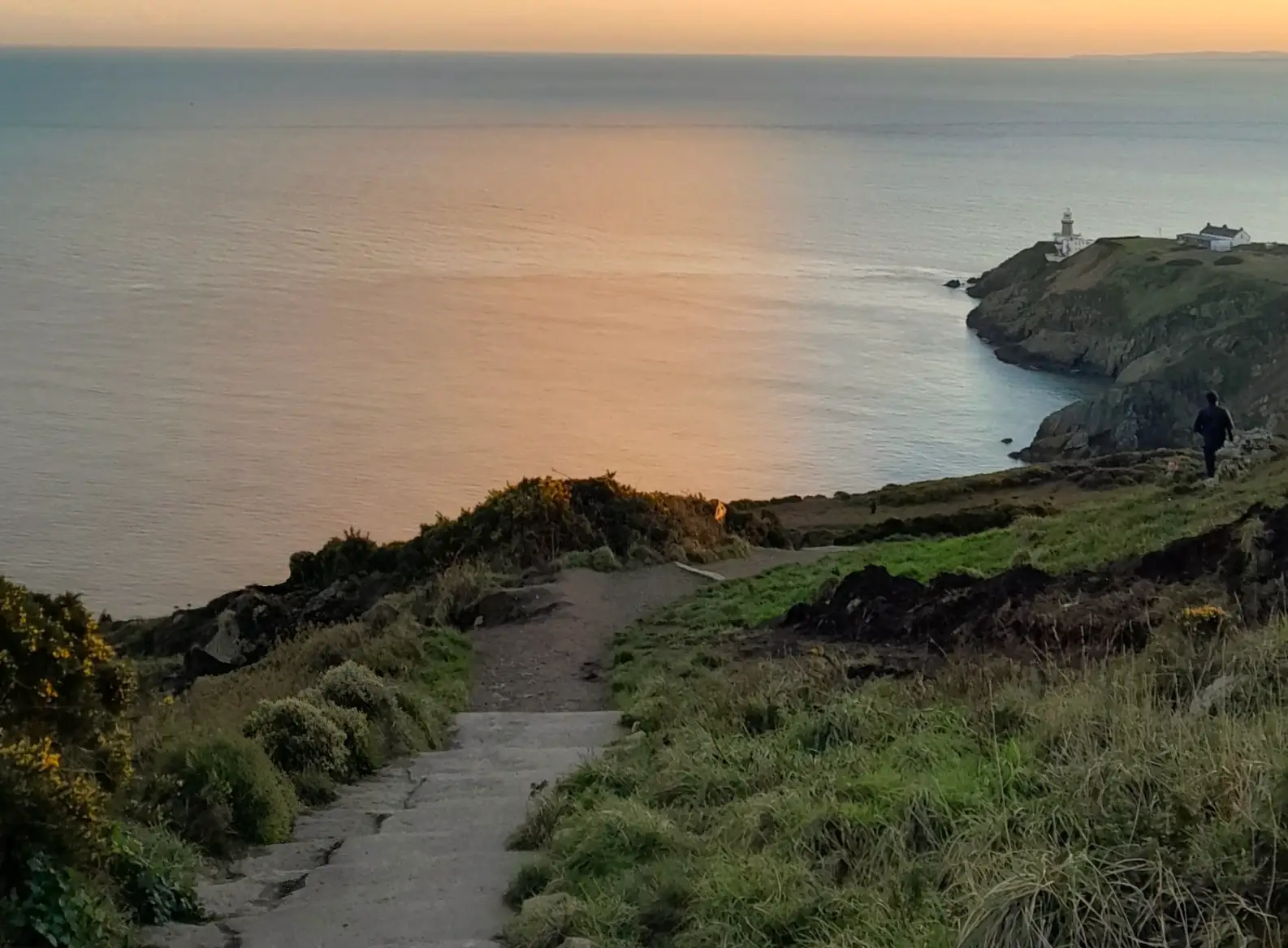 The sun setting over Howth Cliff Walk in Ireland.