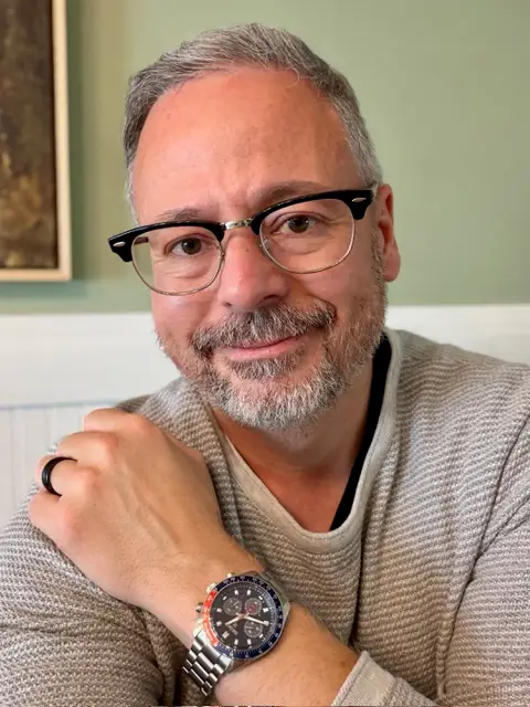 Man showing off analog watch