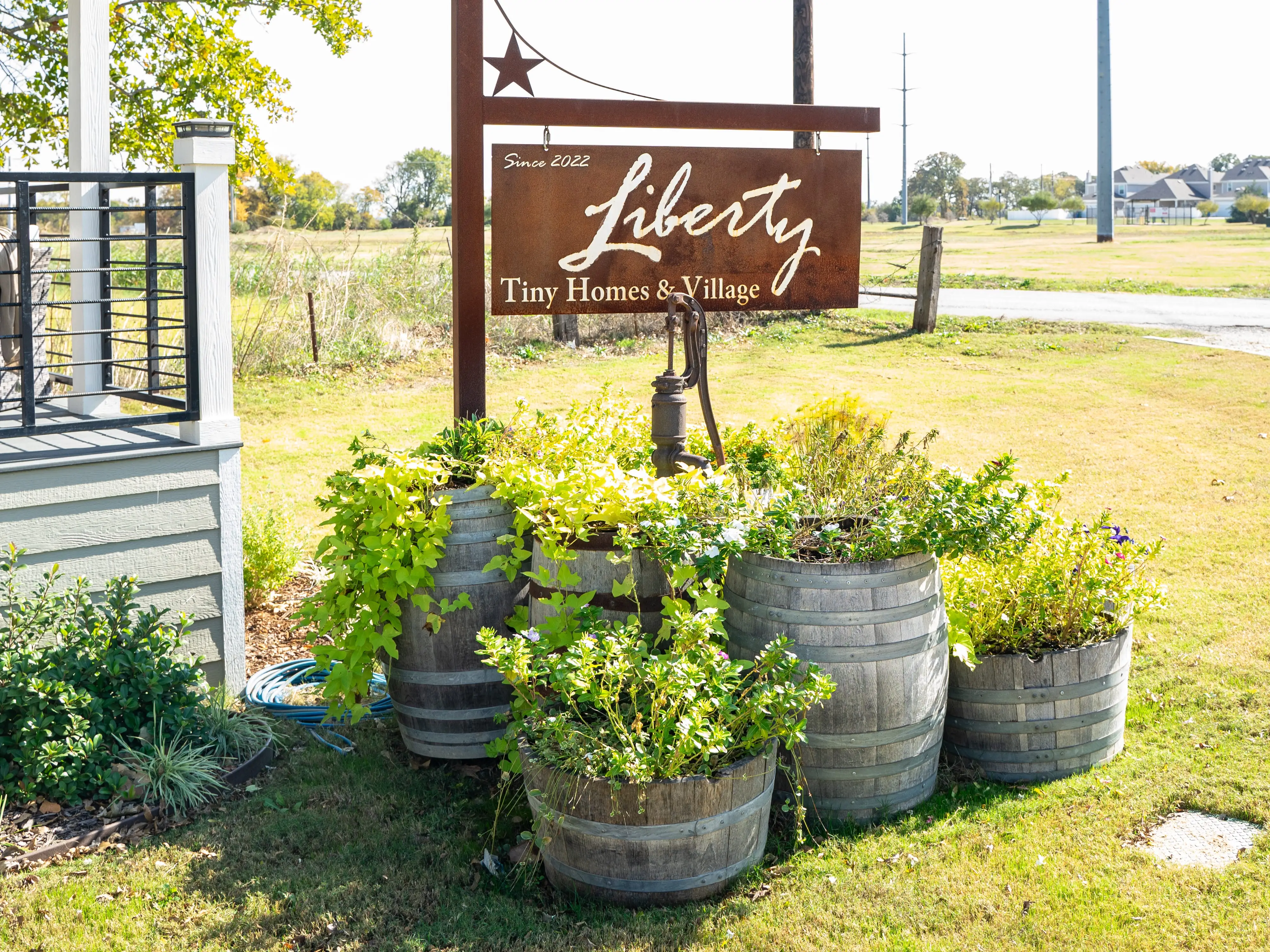 A home stands next to a sign that reads 