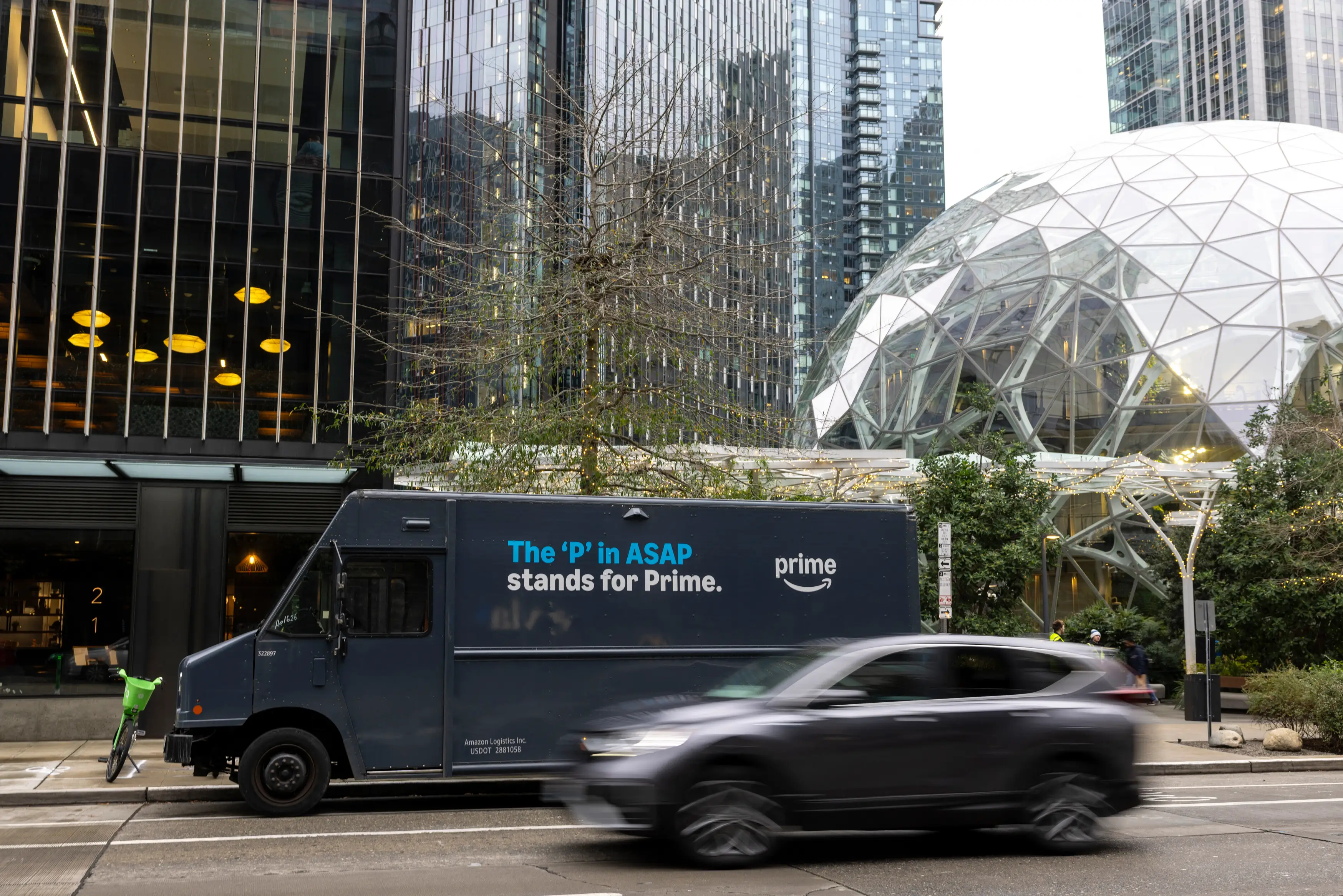 An Amazon Prime delivery van is parked outside Amazon headquarters in Seattle, Washington on January 29, 2026. US online retail and cloud computing giant Amazon said on January 28 it will cut 16,000 jobs worldwide as the company tries to streamline amid its major push into AI. (Photo by Jason Redmond / AFP via Getty Images)
