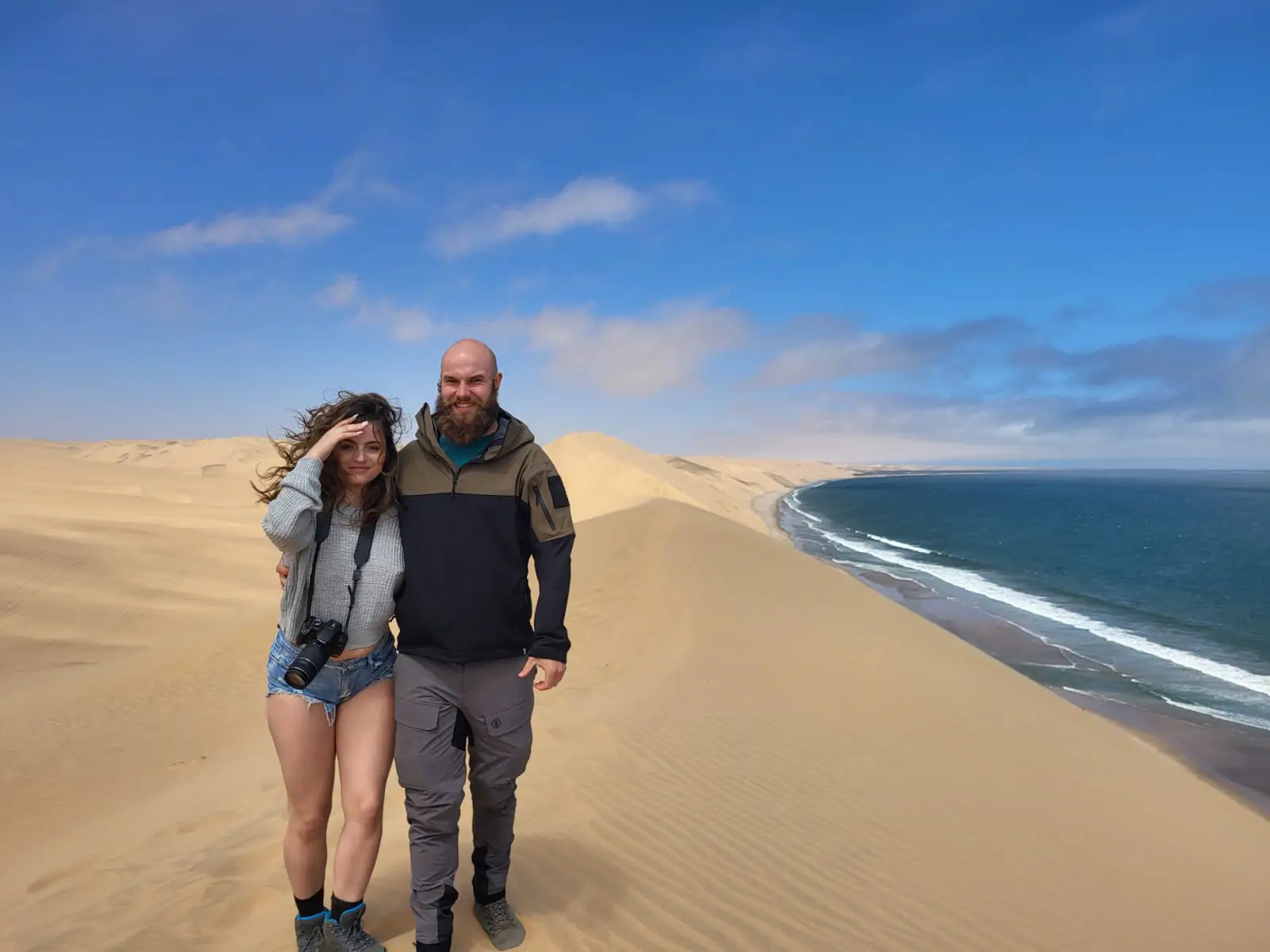 Man and woman standing in desert area together on hike