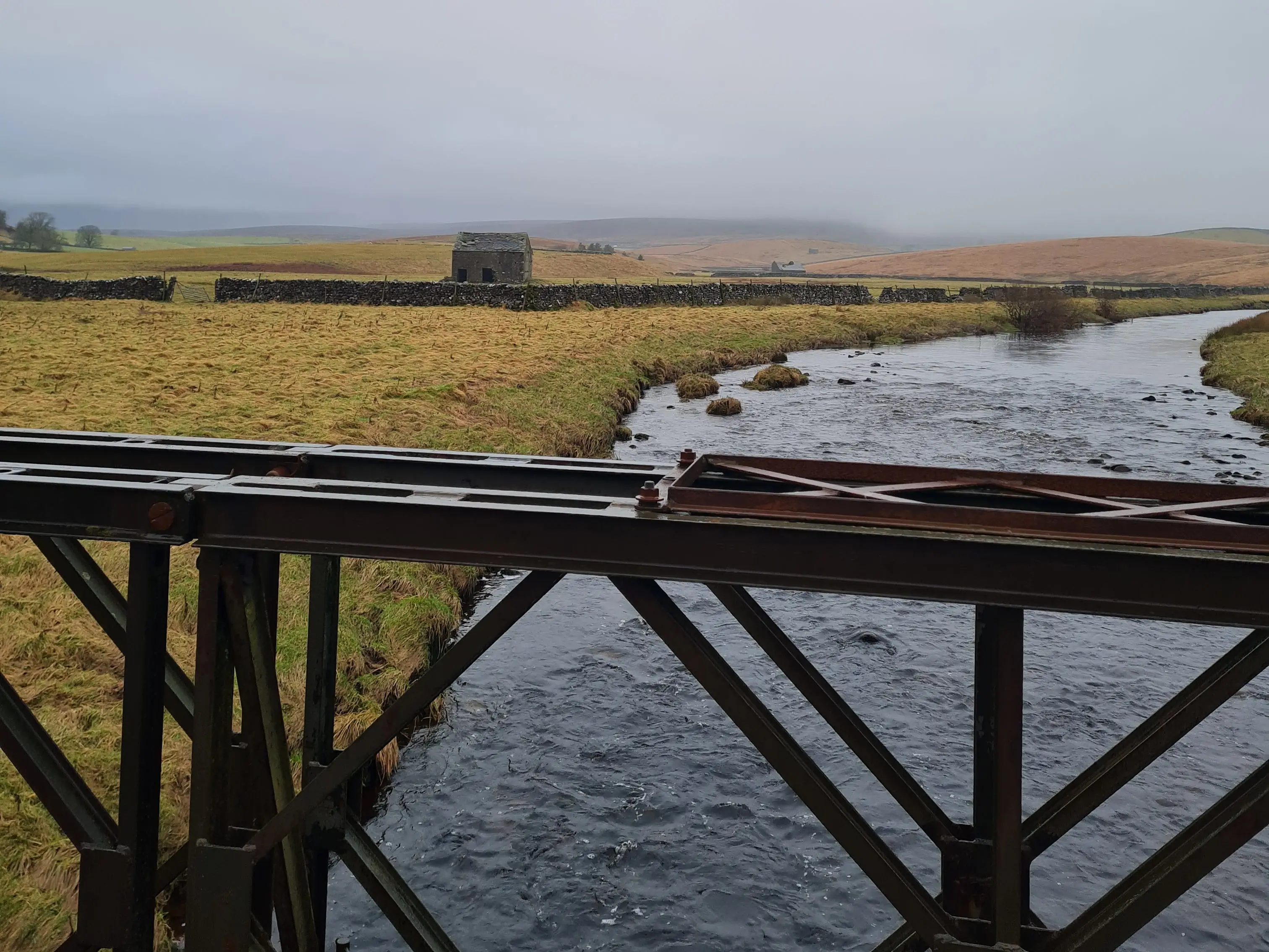 Views of grassy area over bridge