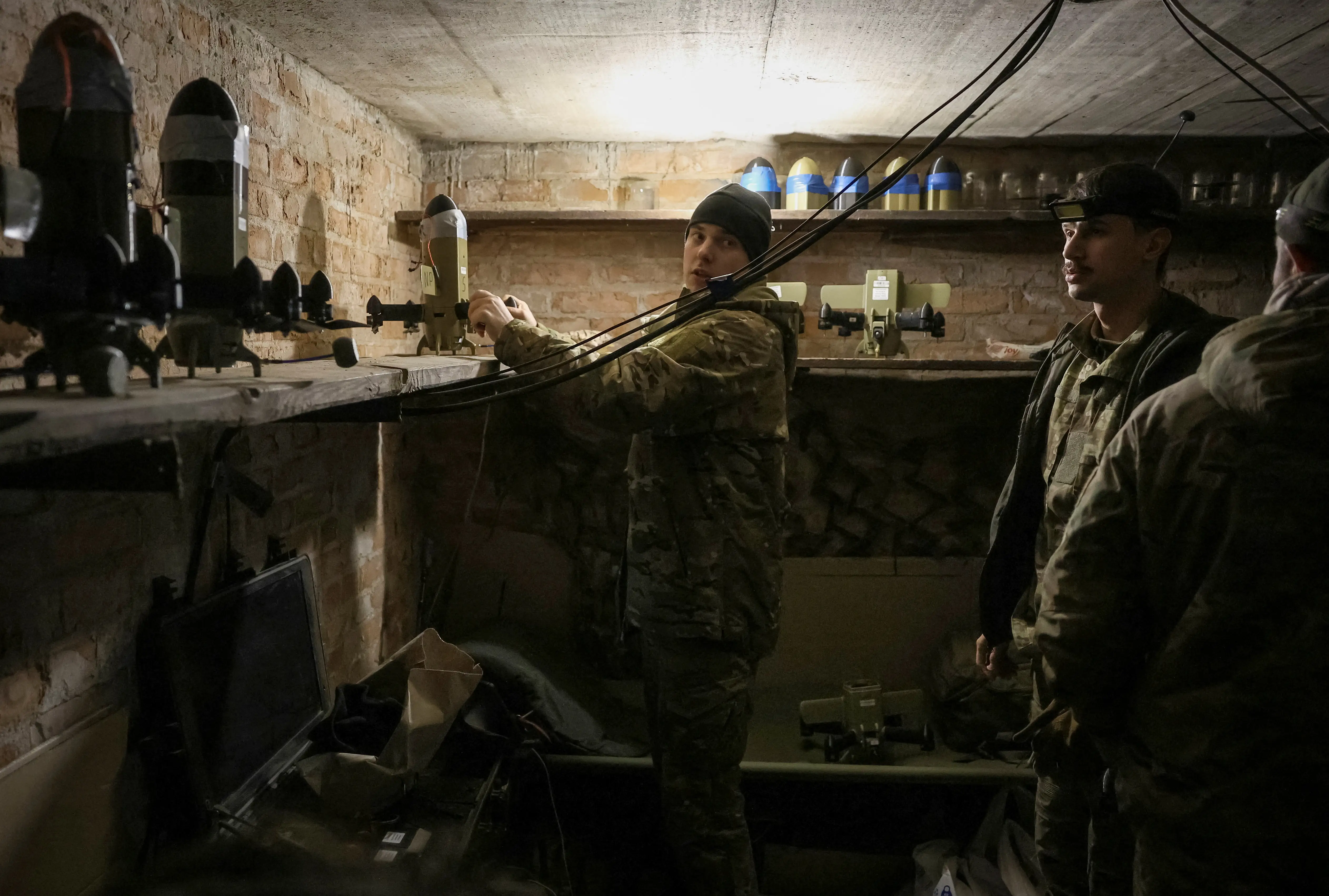 A serviceman from the SQUADRON interceptor unit of the 3rd Army Corps of the Ukrainian Armed Forces prepares a Ukrainian drone-interceptor Sting for a flight at their front line position, amid Russia's attack on Ukraine, near the frontline in eastern Ukraine, October 30, 2025.