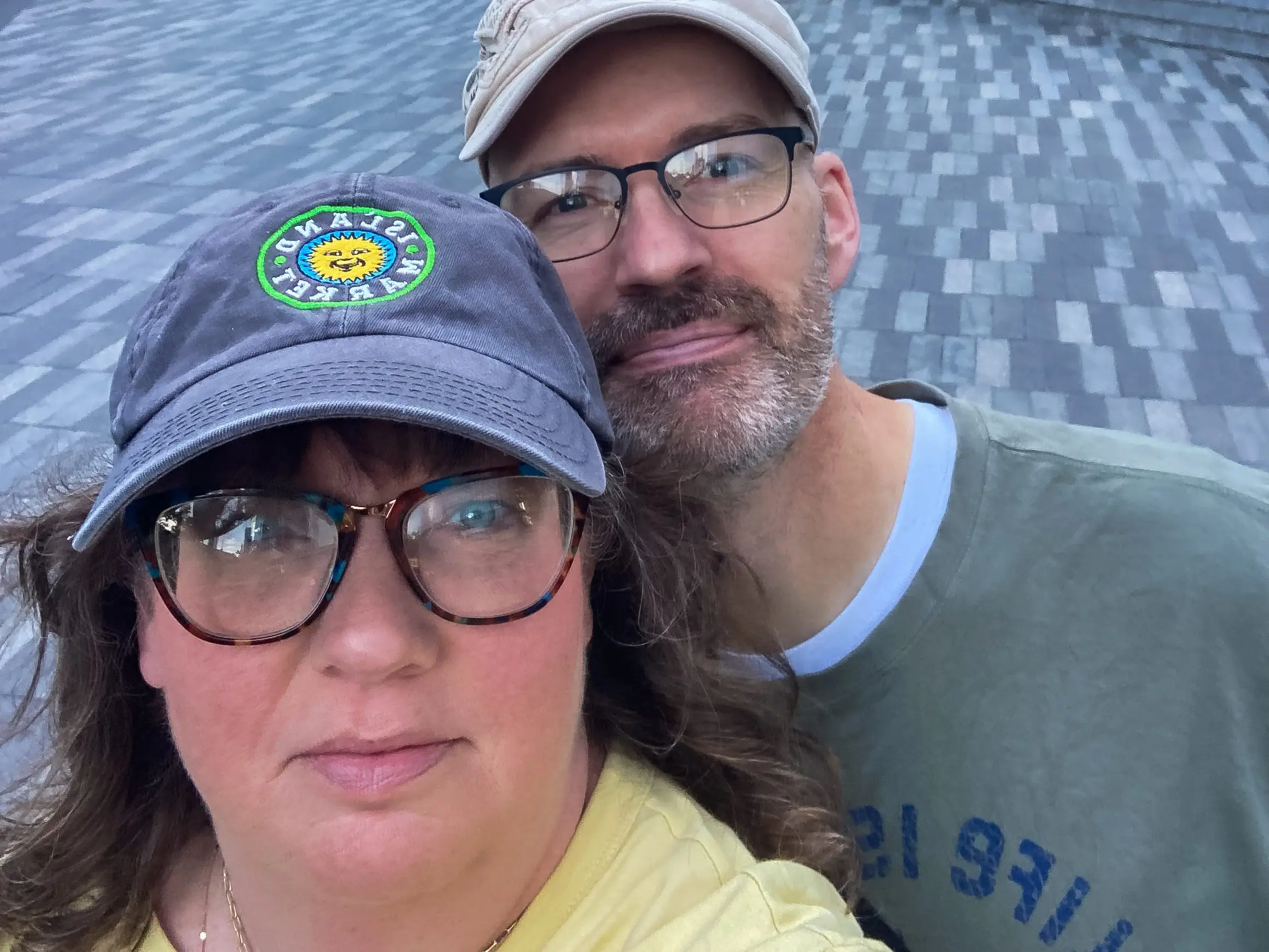 Man and woman wearing hats, smiling