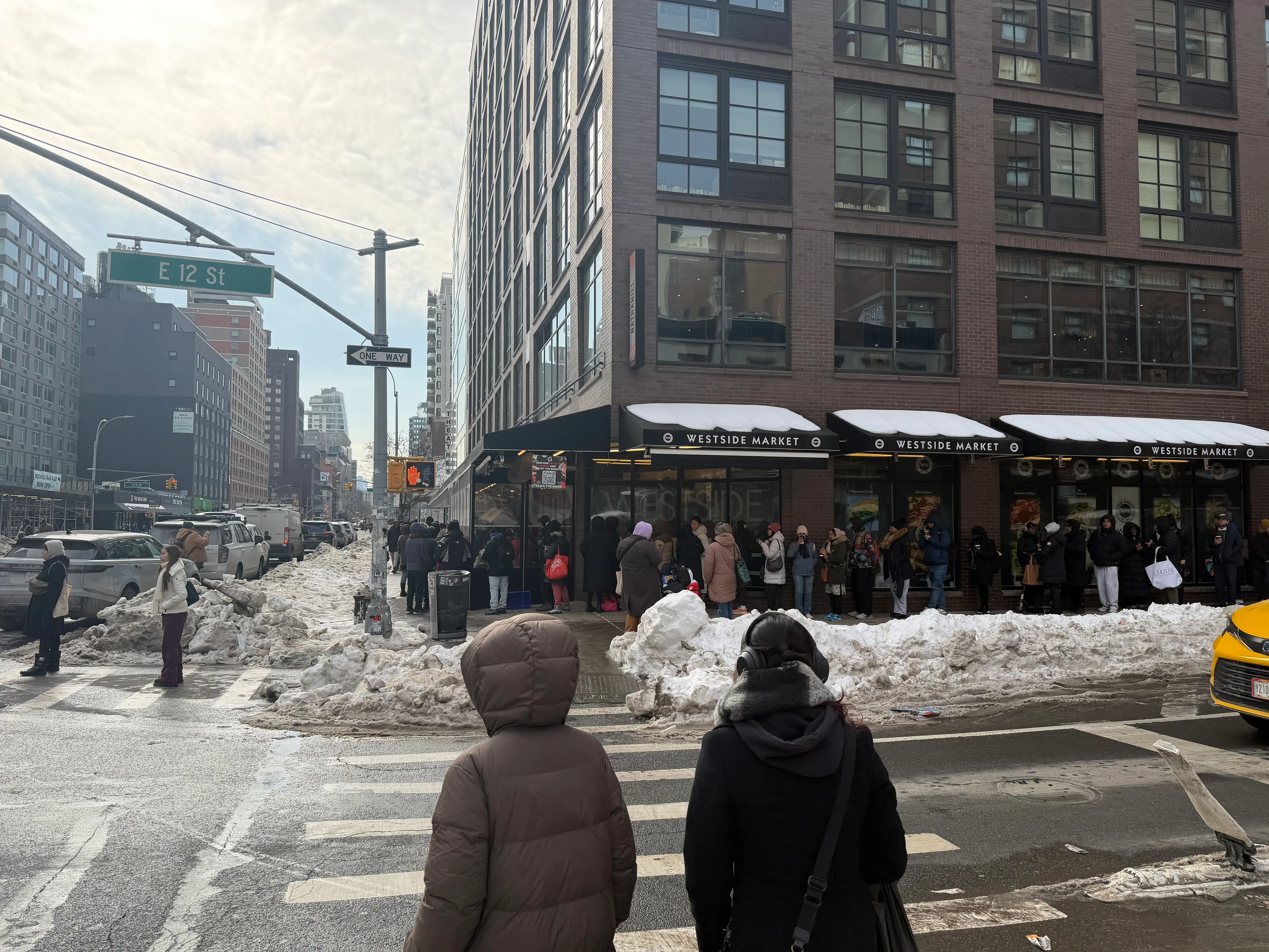 The line outside the Westside Market on E 12 St is pictured.