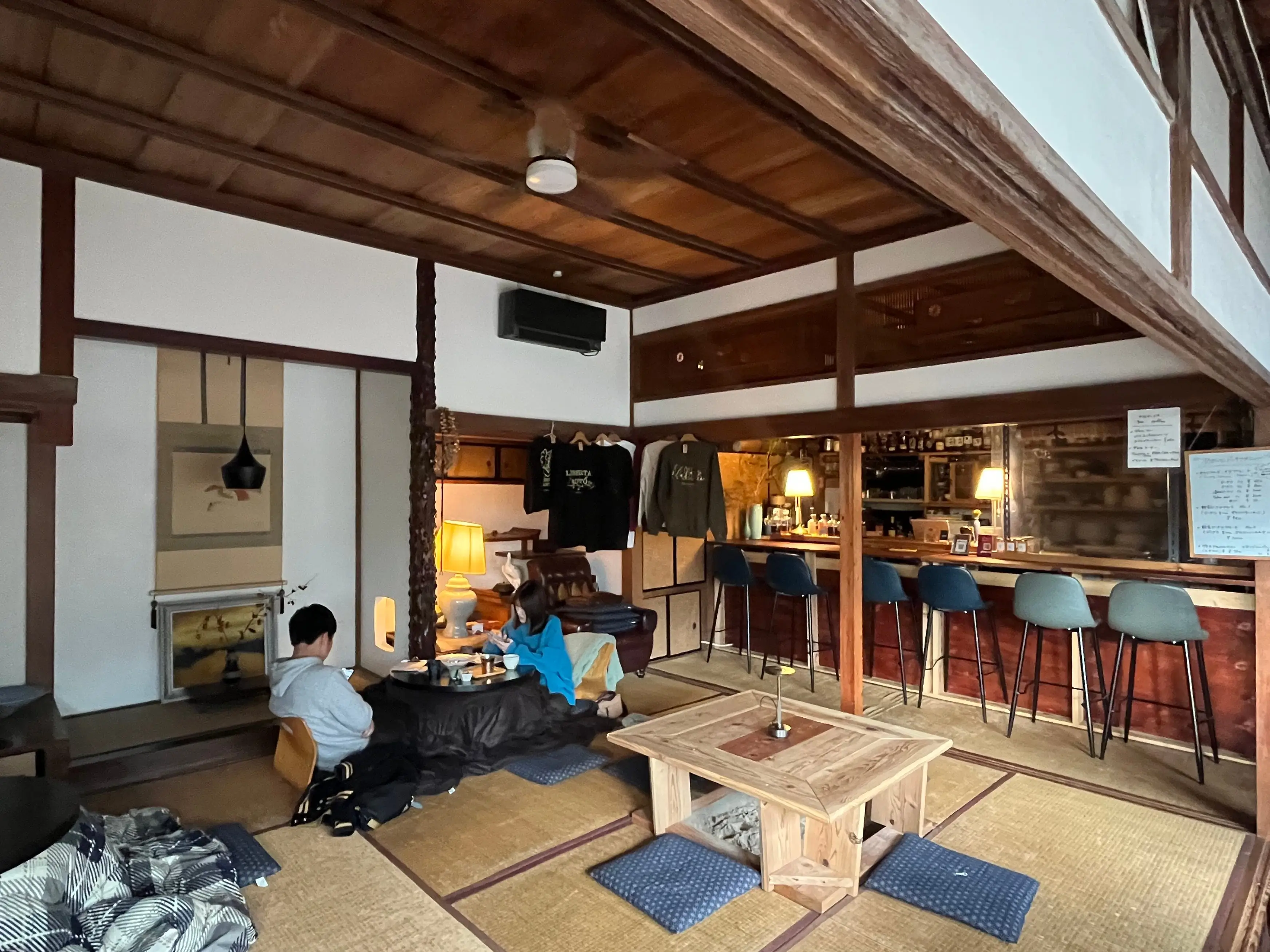 A couple sitting on tatami mats at Aoito cafe in Zushi, Japan.