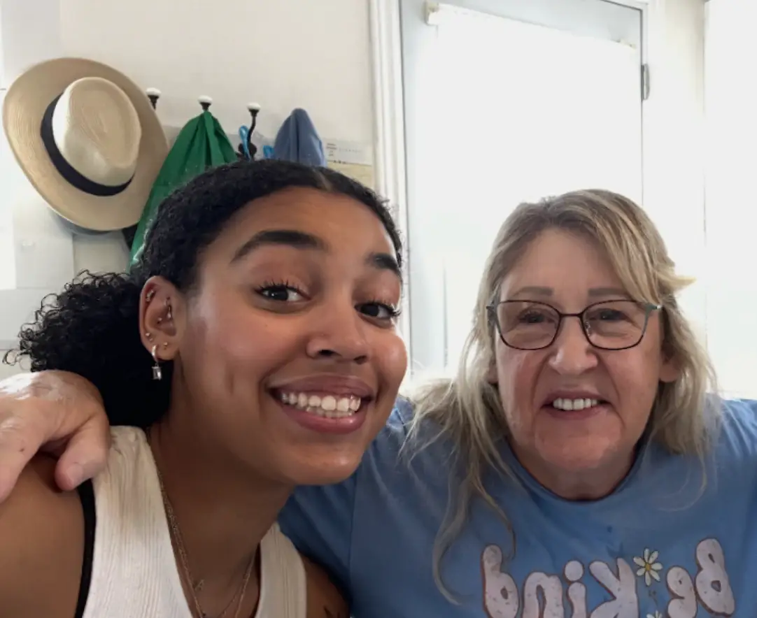 The writer and her grandmother posing for a selfie and smiling in her grandparents' house.