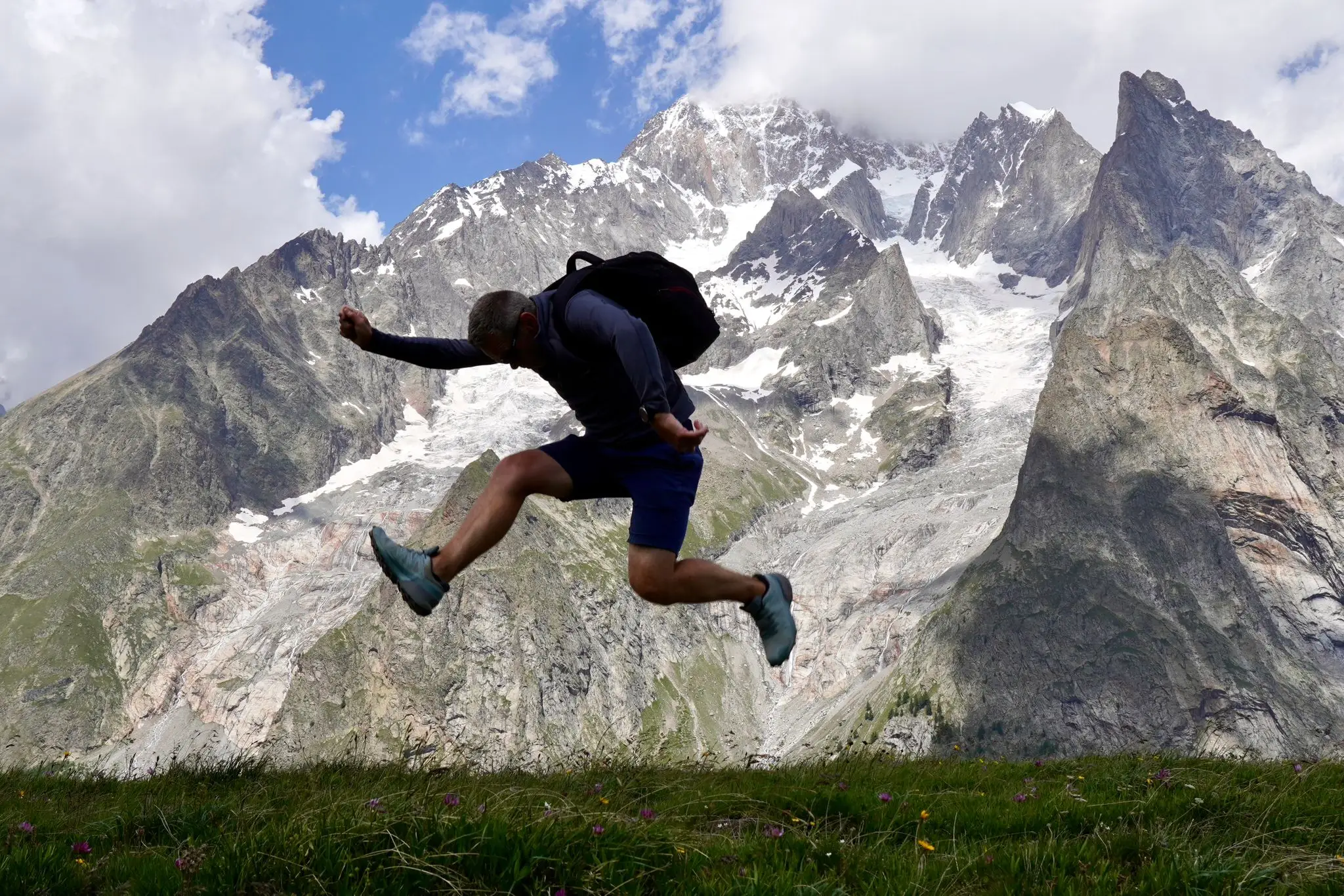 Man jumping in the air in front of a mountain