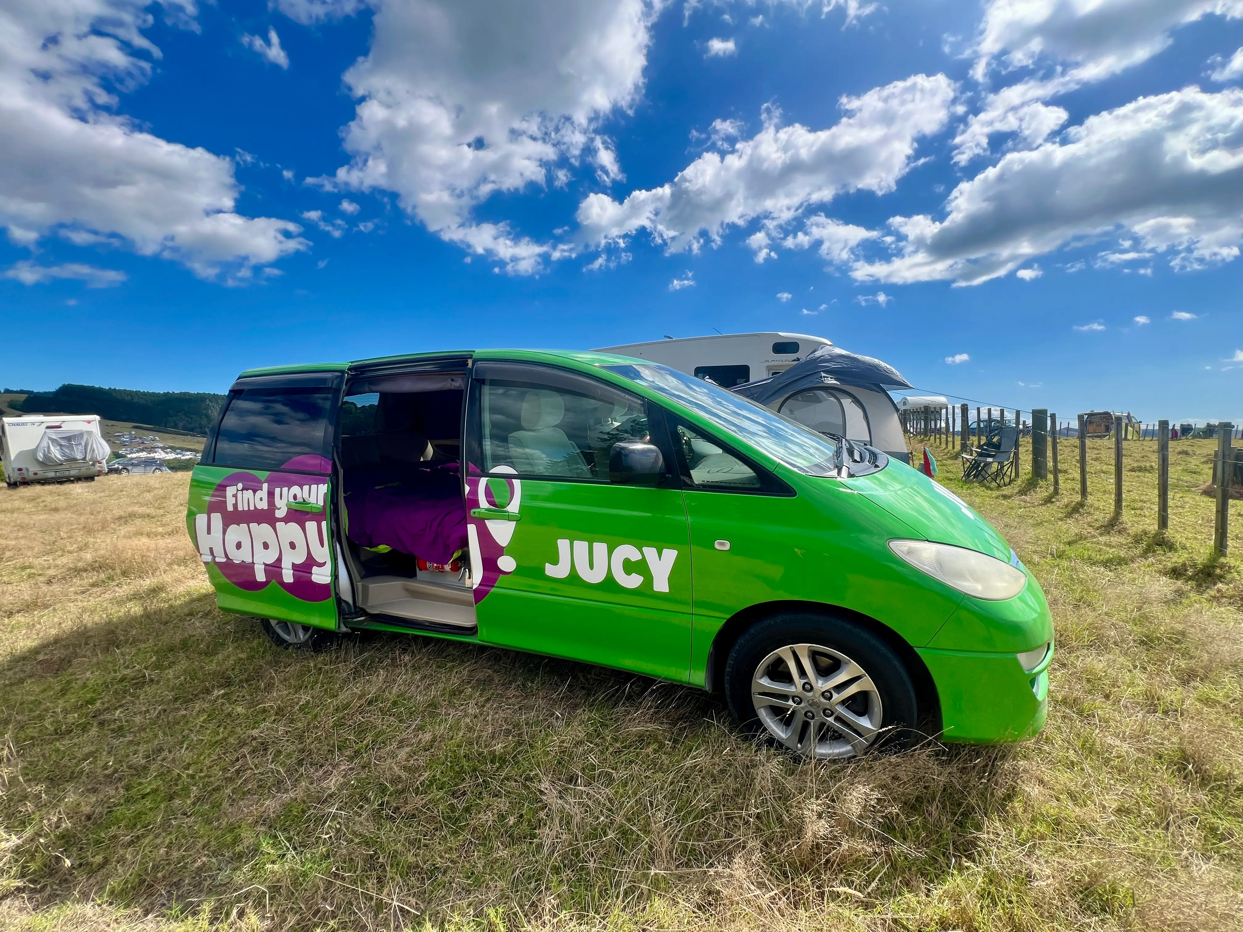 Green van parked in field