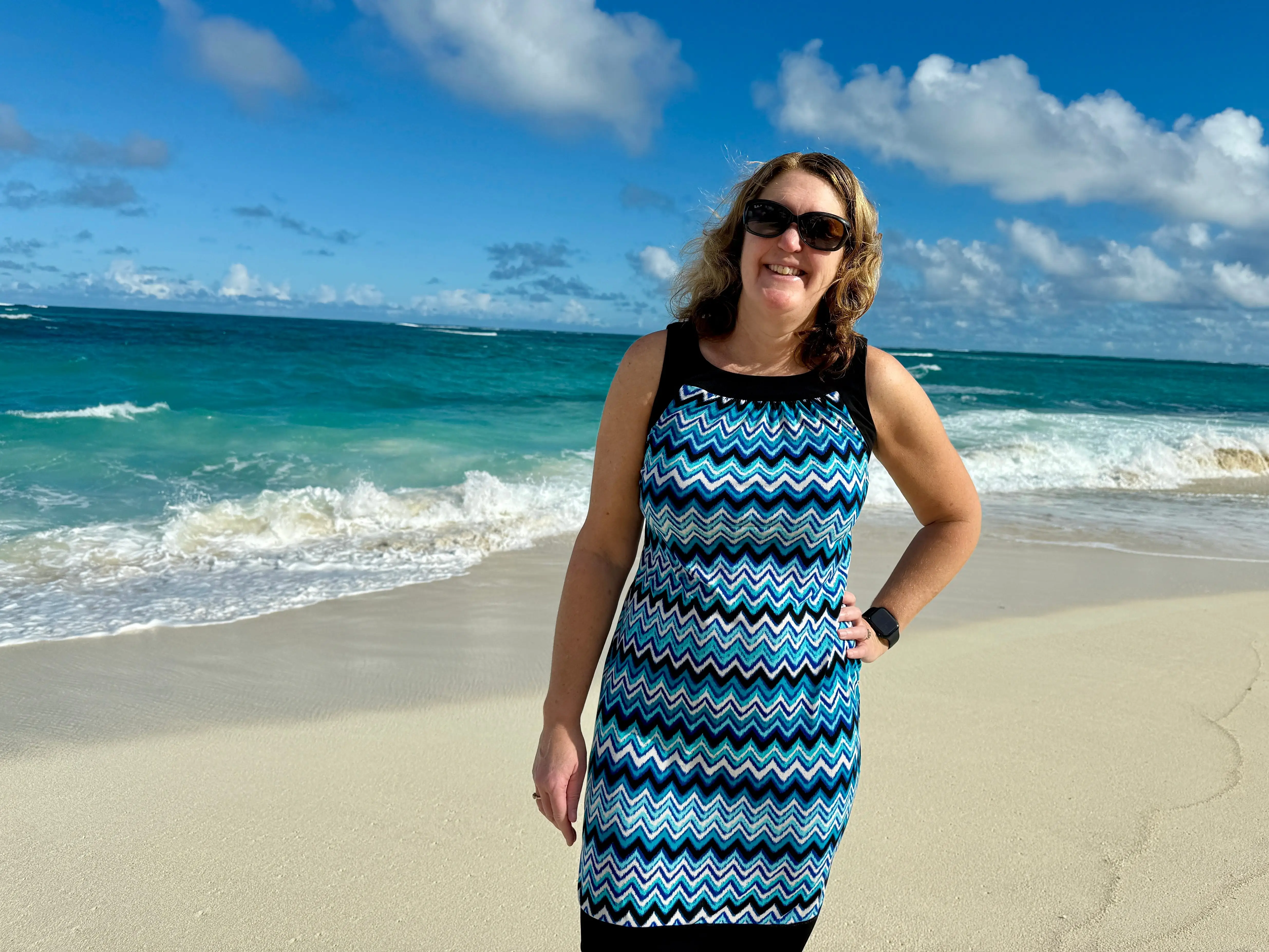 Cheryl Maguire standing in front of the ocean in the Caribbean
