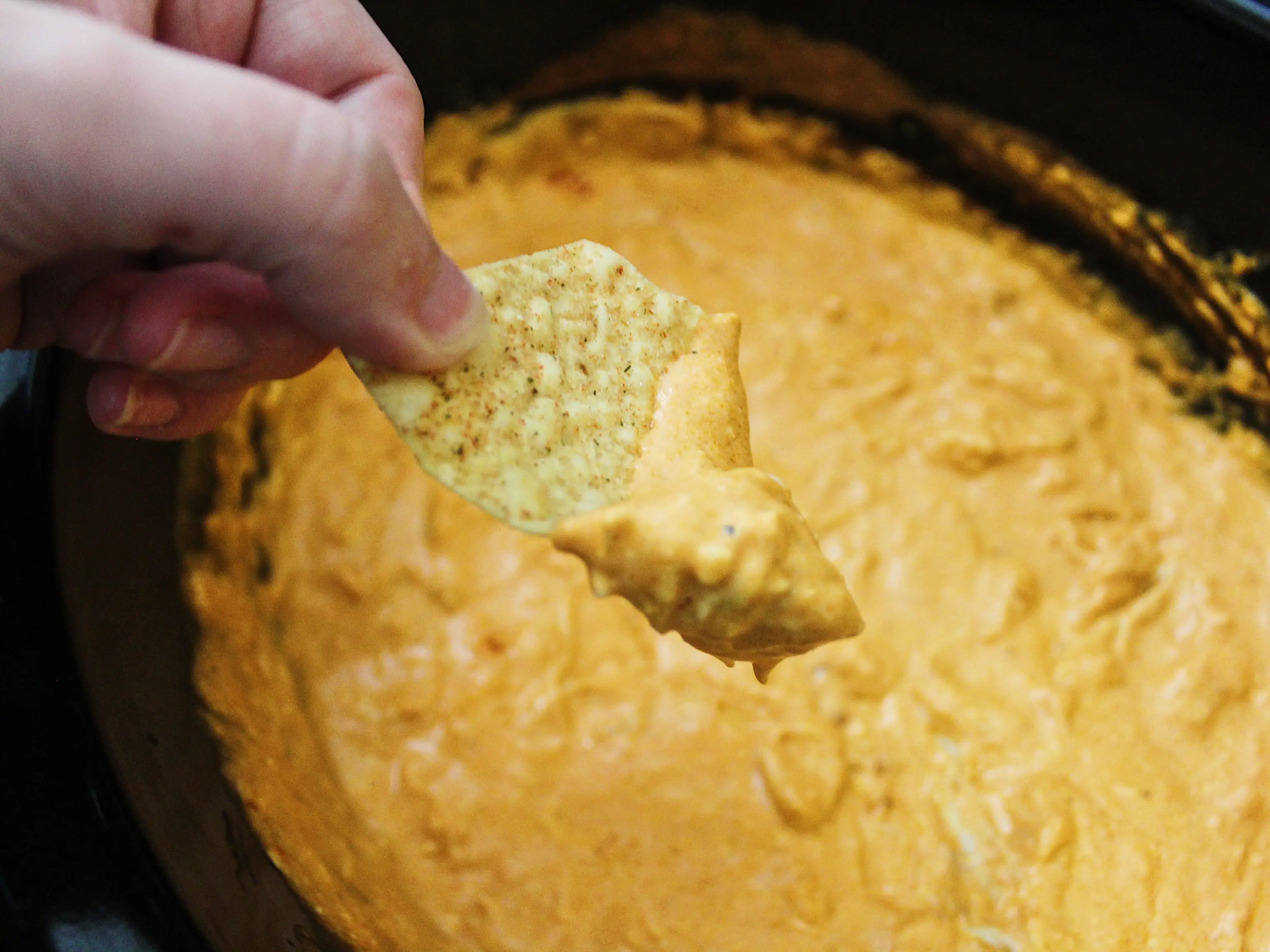 tortilla chip dipped in buffalo chicken dip