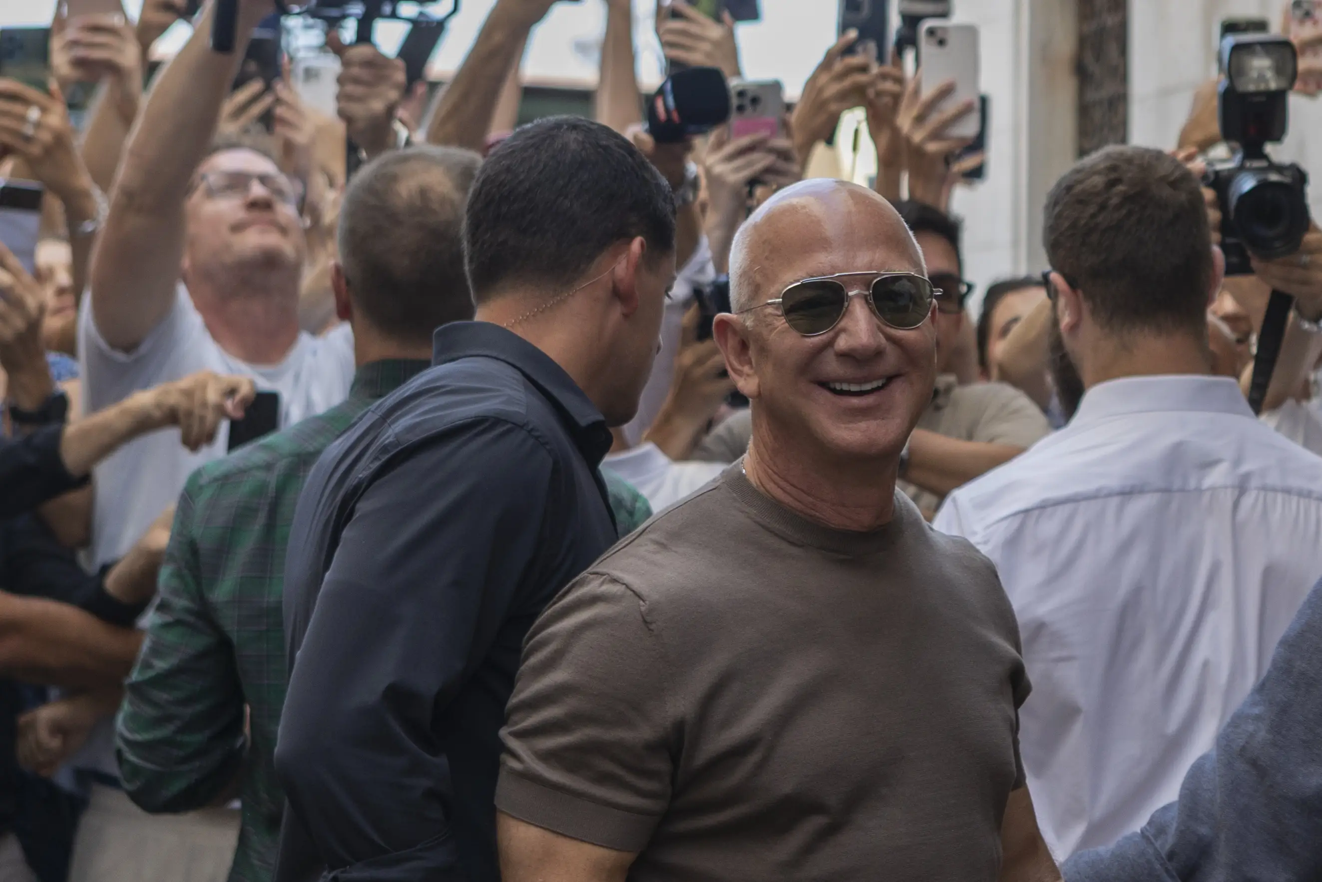 Jeff Bezos leaves a restaurant, surrounded by a crowd, in Venice, Italy; June 2025