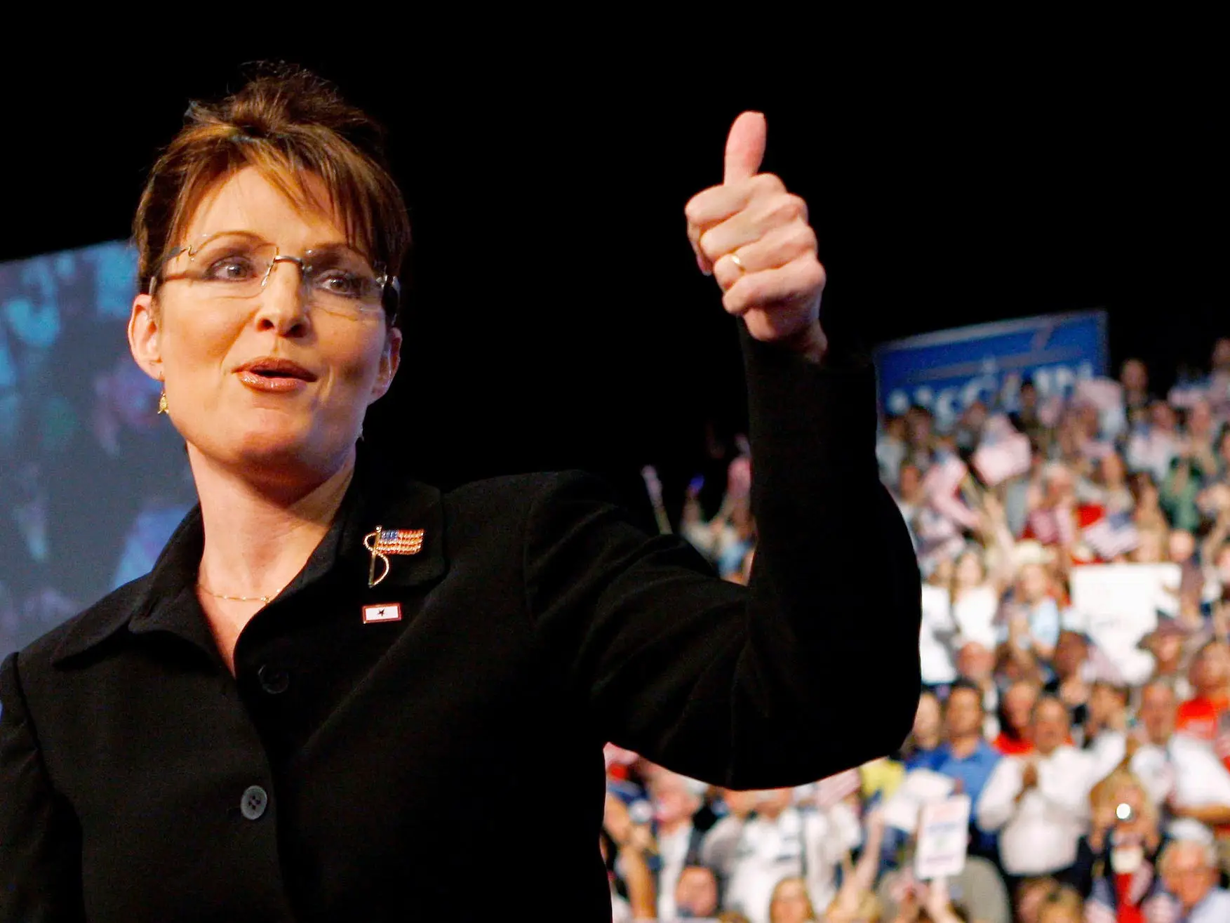 US Republican presidential candidate Senator John McCain (R-AZ) looks on as his vice presidential running mate, Alaska Governor Sarah Palin (R) gestures to the crowd at a campaign event in Dayton, Ohio August 29, 2008.