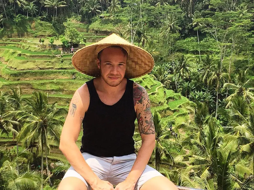 Man wearing a traditional farming hat in Bali, Indonesia.