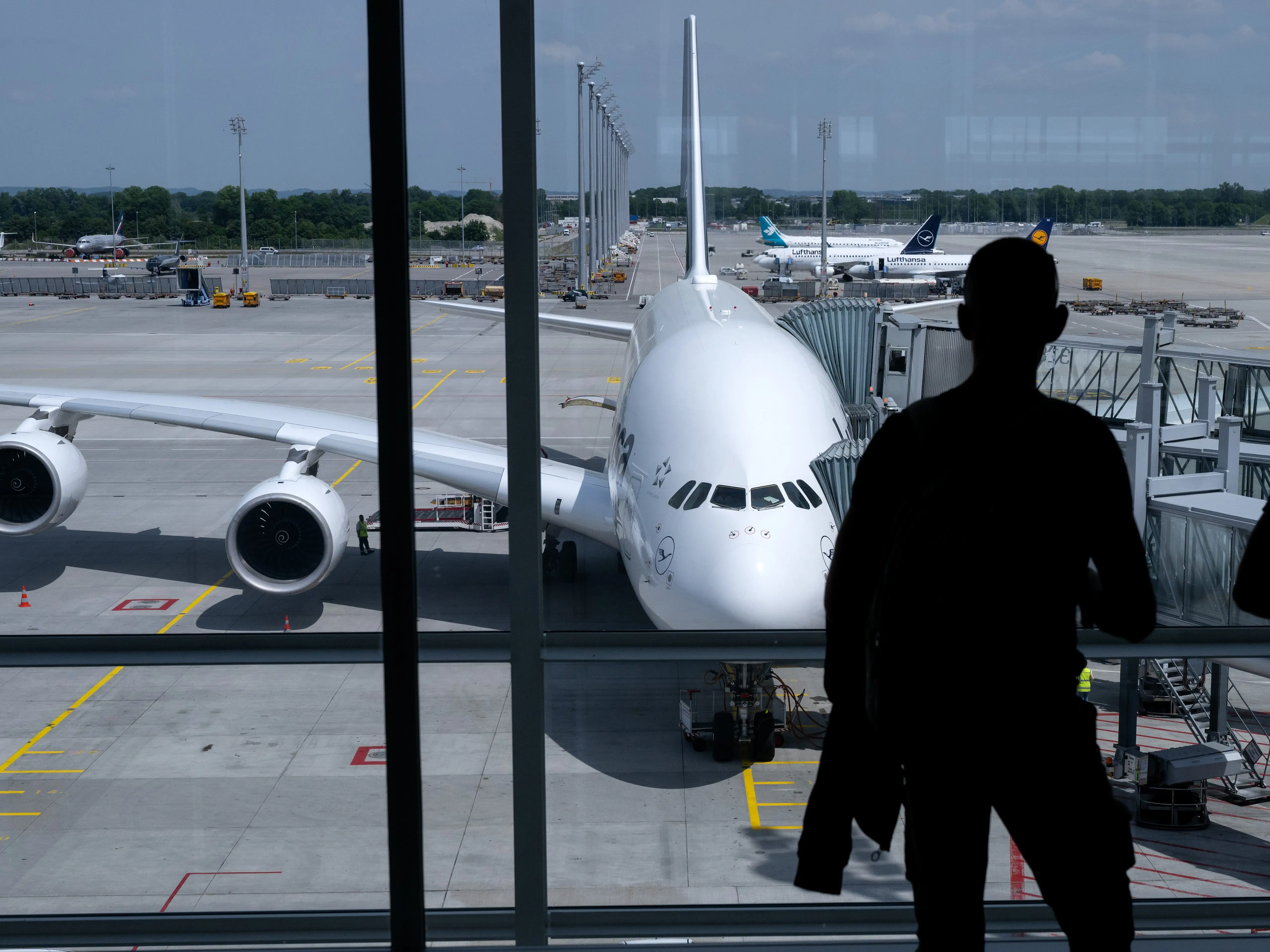 People stand in front of the Lufthansa A380.