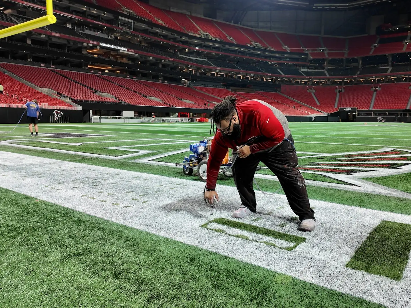 a person repainting mercedes-benz stadium in atlanta