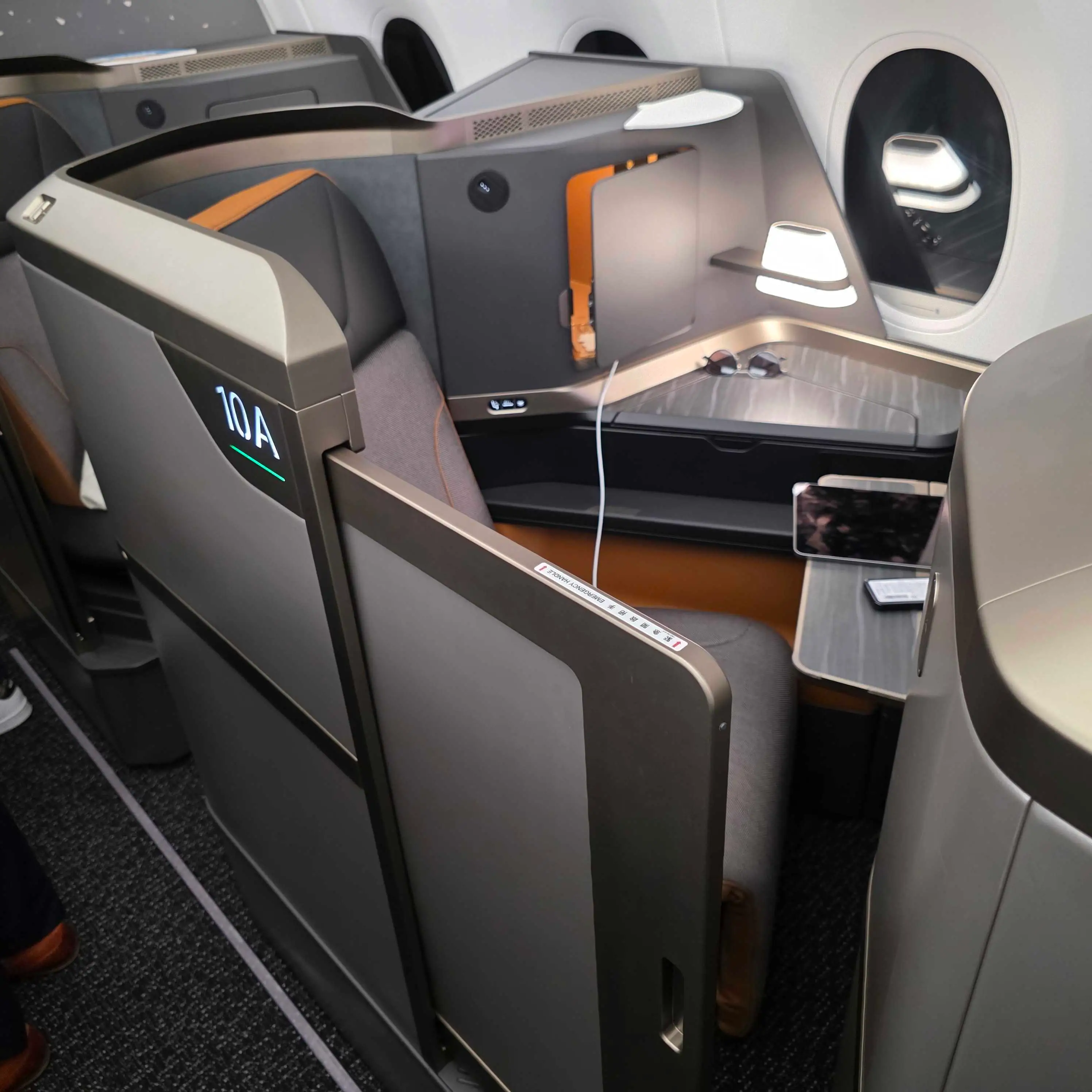 An example of devices and personal belongings left on a Starlux A350-1000 Business Class seat.