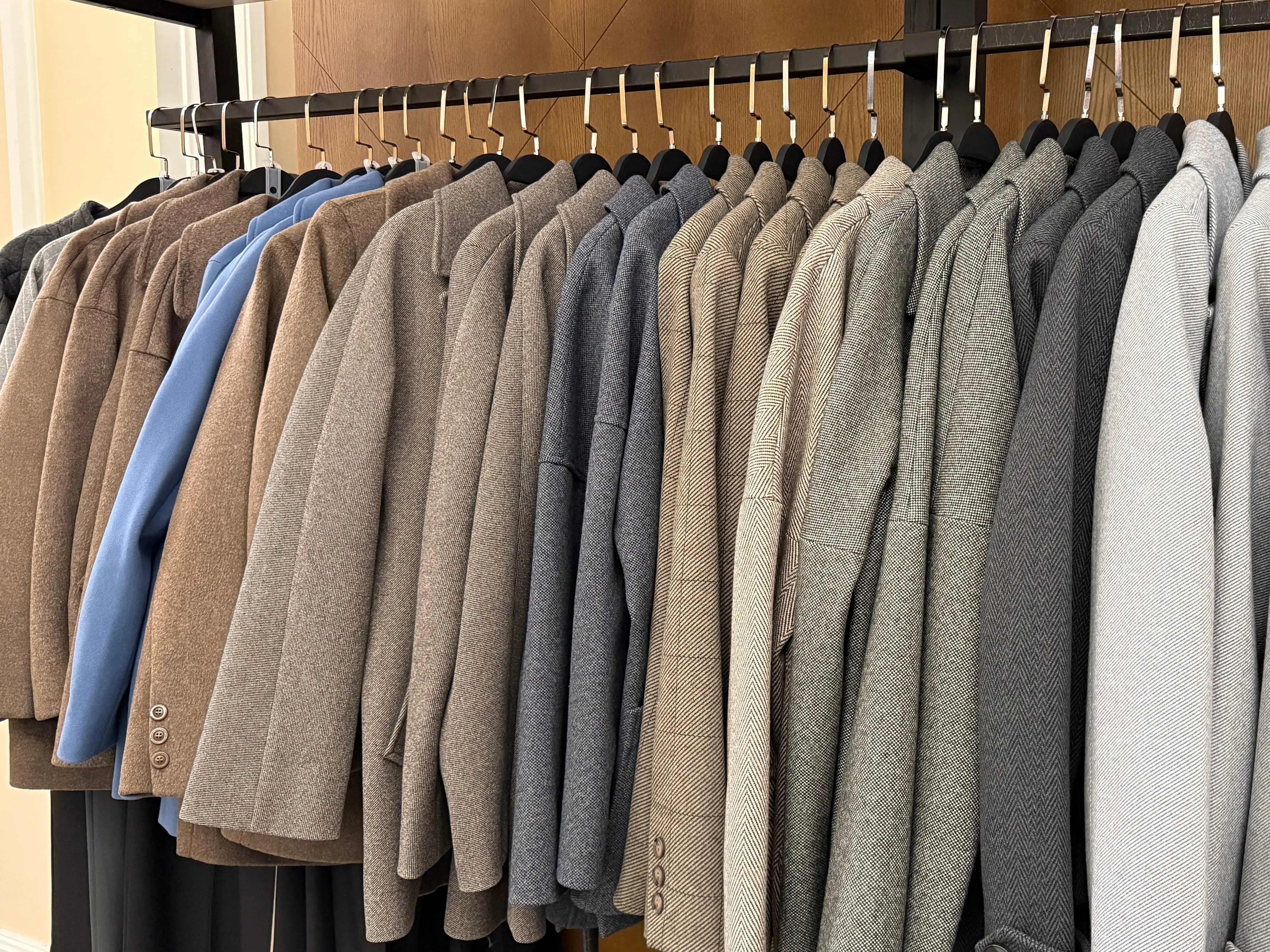 Row of suit jackets hanging in closet