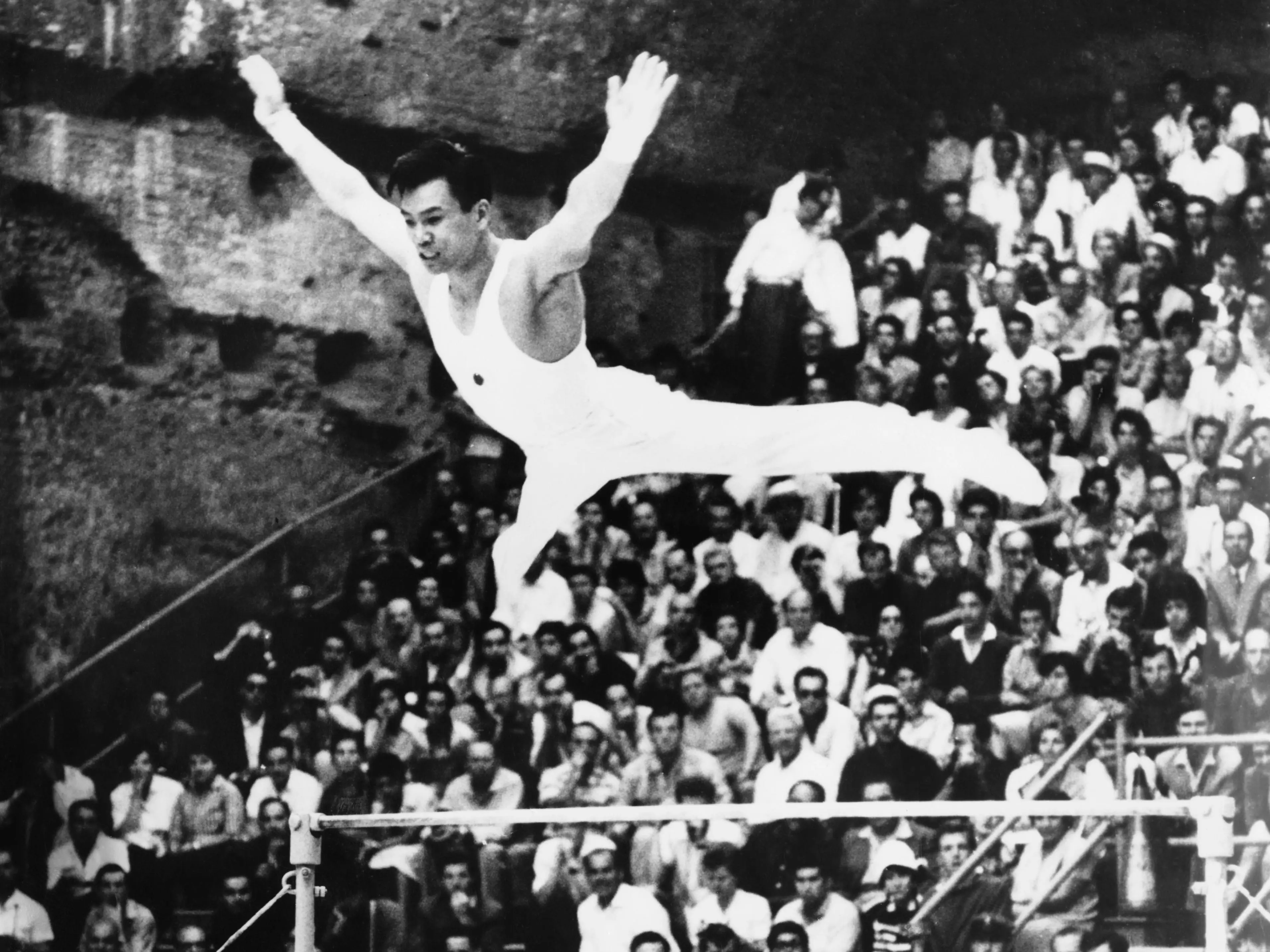 Japanese gymnnast Takashi Ono competing on the uneven bars in the men's individual all-around gymnnastics event at the Baths of Caracalla during the Olympic Games in Rome, 7th September 1960.