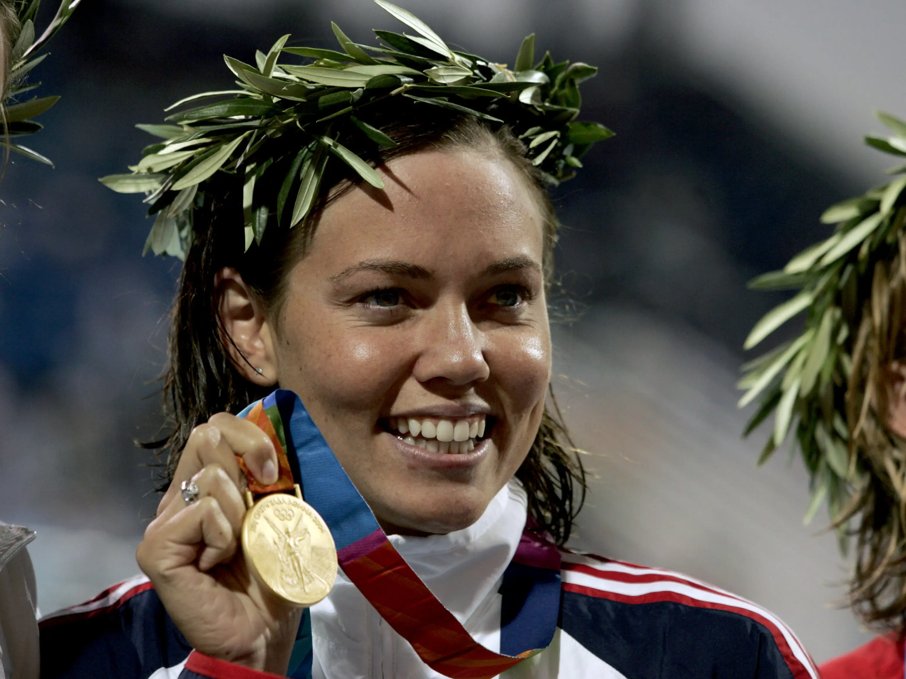Closeup of USA Natalie Coughlin victorious with gold medal after Women's 100M Backstroke Final at Olympic Aquatic Centre. Athens, Greece