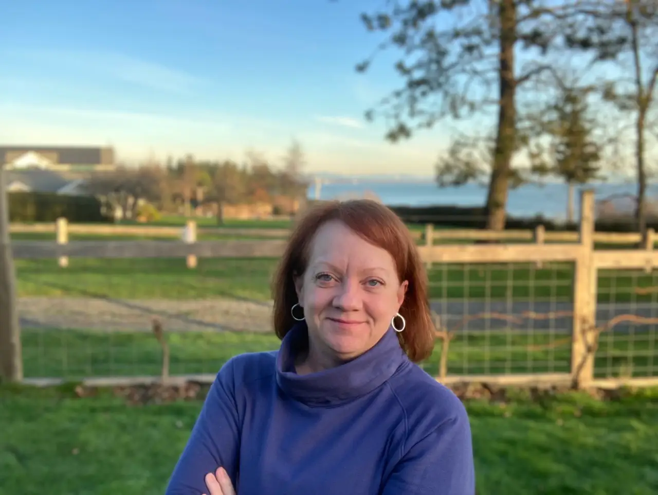Woman smiling in front of fence