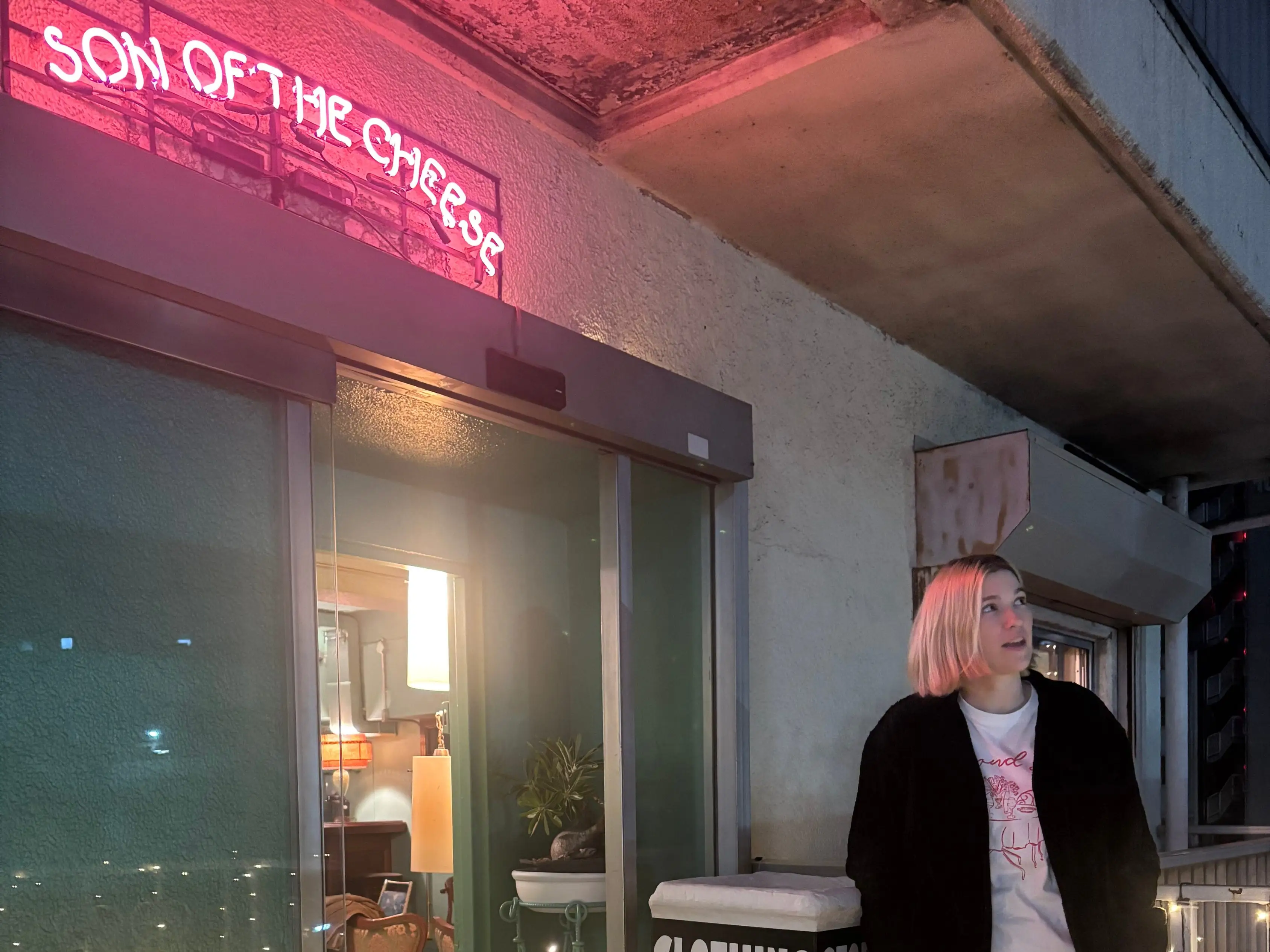 Lauren Rose Kocher posing outside of SOn of the Cheese, a clothing store in Japan.