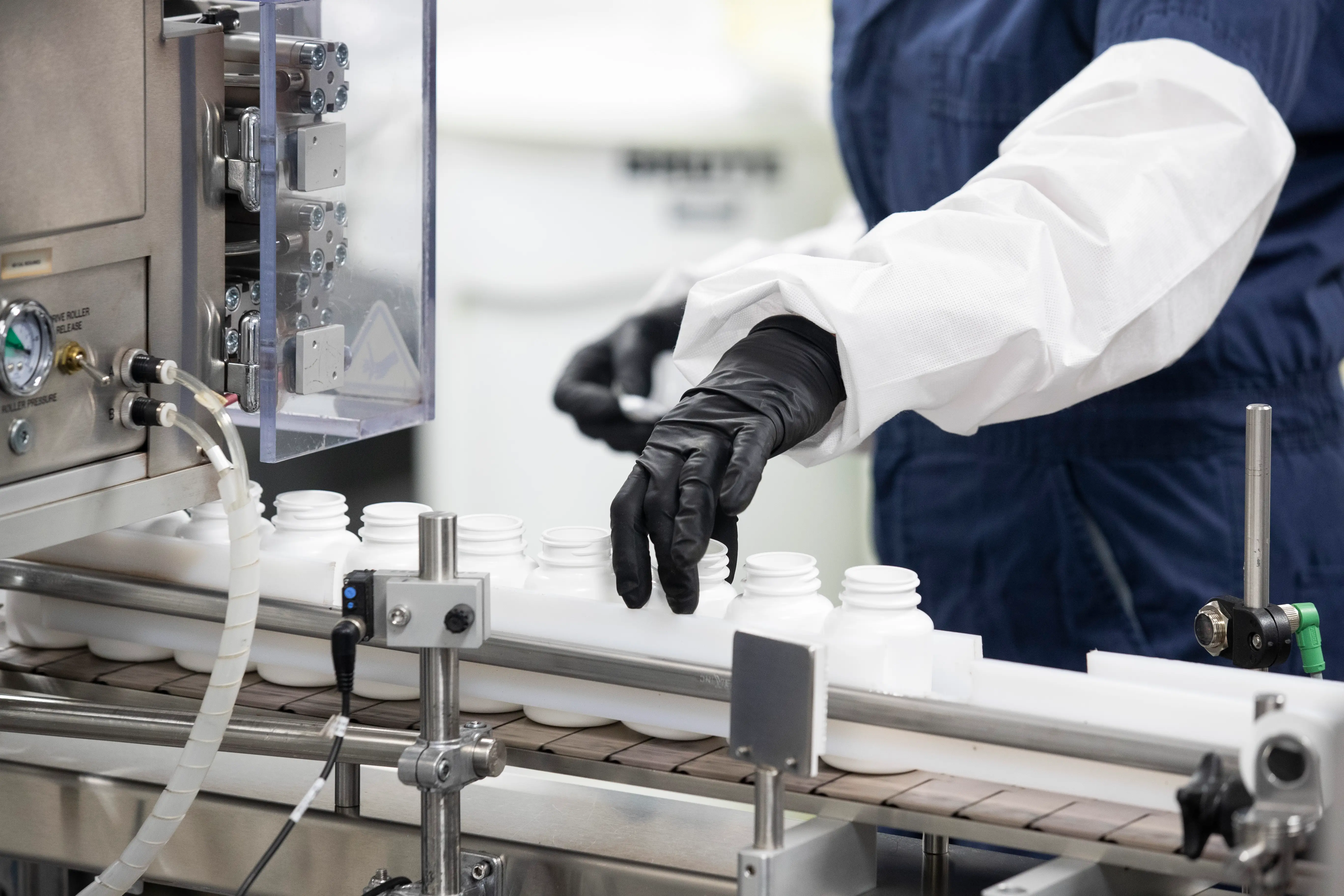 Workers adjust bottles heading into the packing line at the Thorne manufacturing facility, Friday, September 5, 2025, in Summerville.