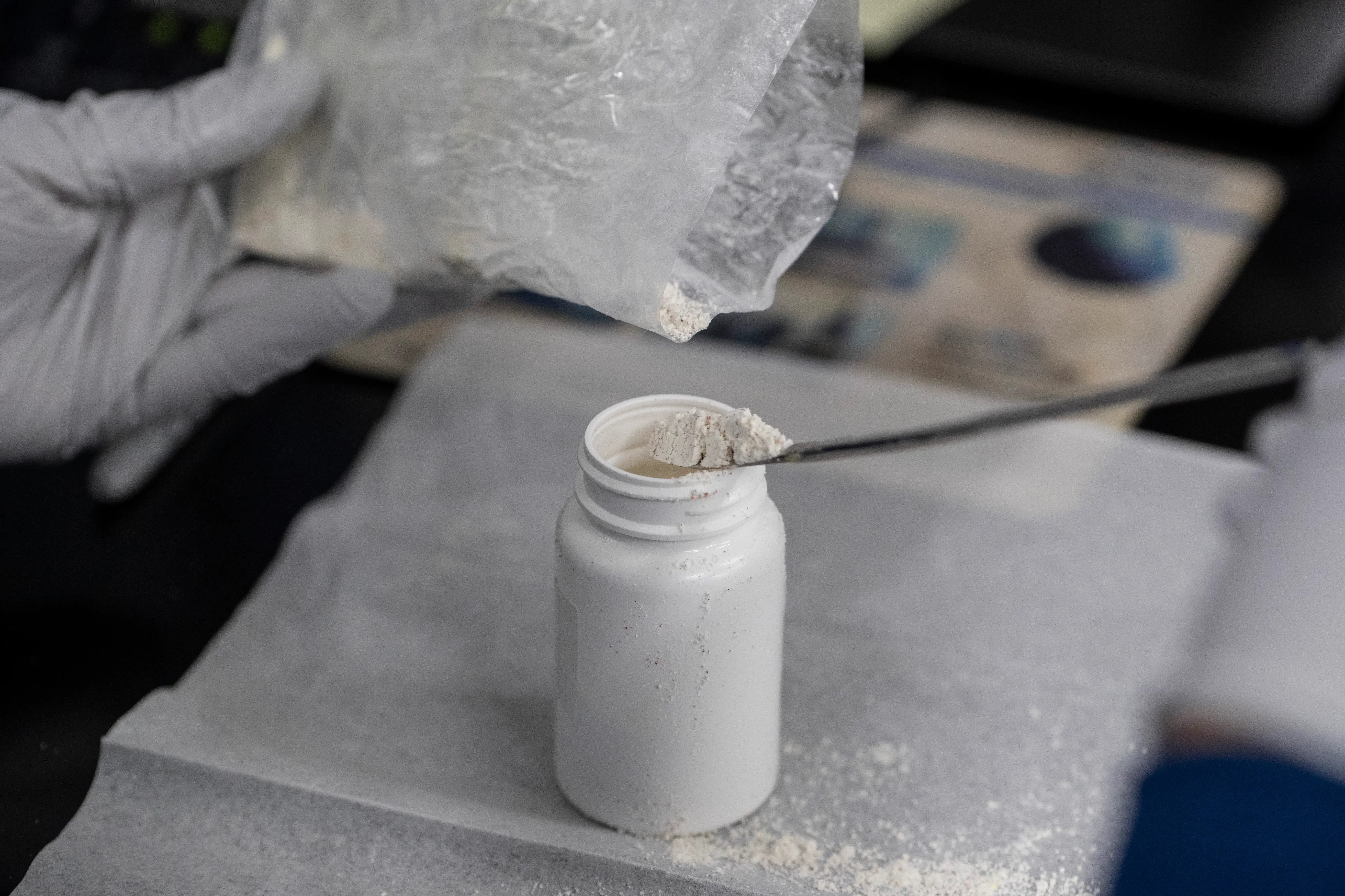 A worker measures out material to be packaged into a bottle inside the Thorne manufacturing facility's labs, Friday, September 5, 2025, in Summerville.