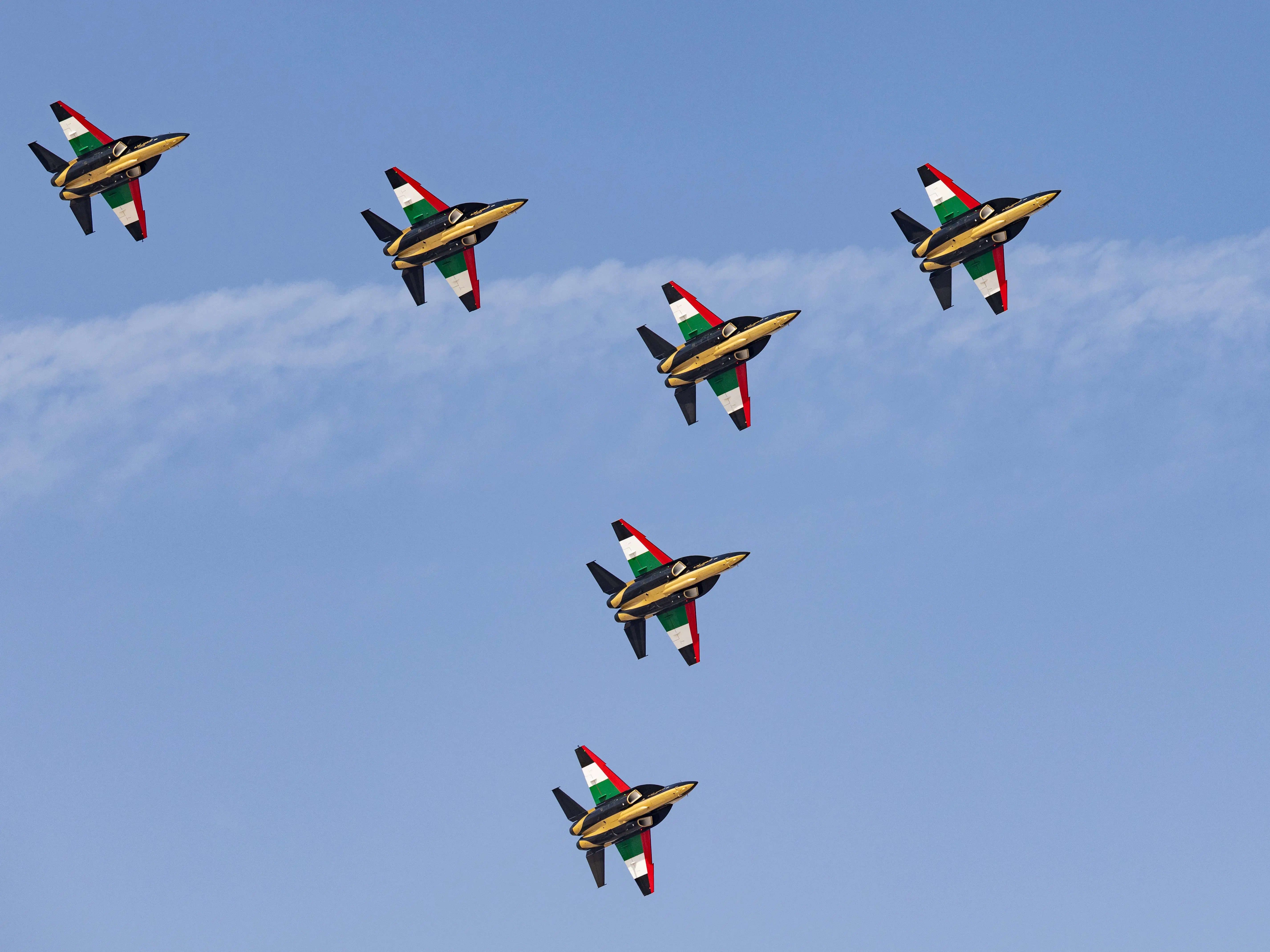 The United Arab Emirates Air Force's newly re-equipped Fursan Al-Emarat aerobatic display team flies the Hongdu L-15 advanced jet trainer from China at the Dubai Airshow on November 16, 2025 in Dubai, United Arab Emirates.
