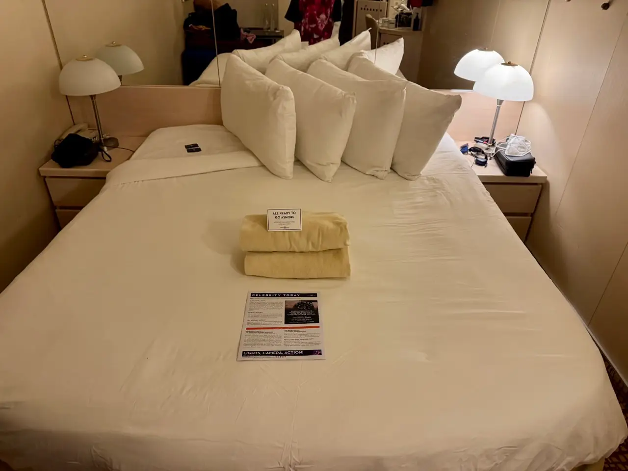 Bed in interior cabin with four pillsw on it on Celebrity Constellation