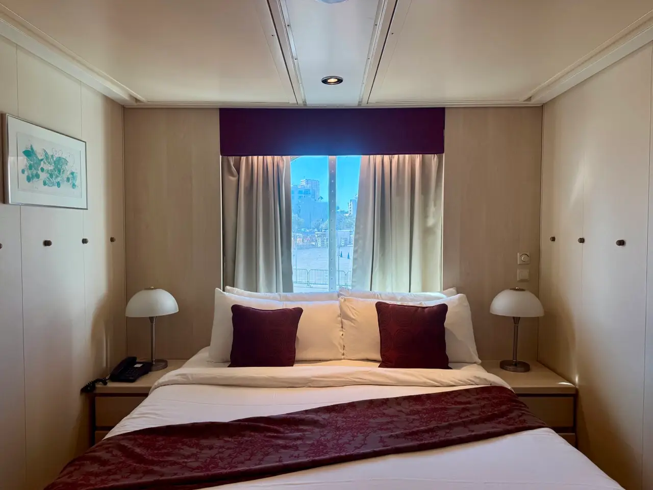 Bed under window in ocean-view stateroom on Celebrity Constellation
