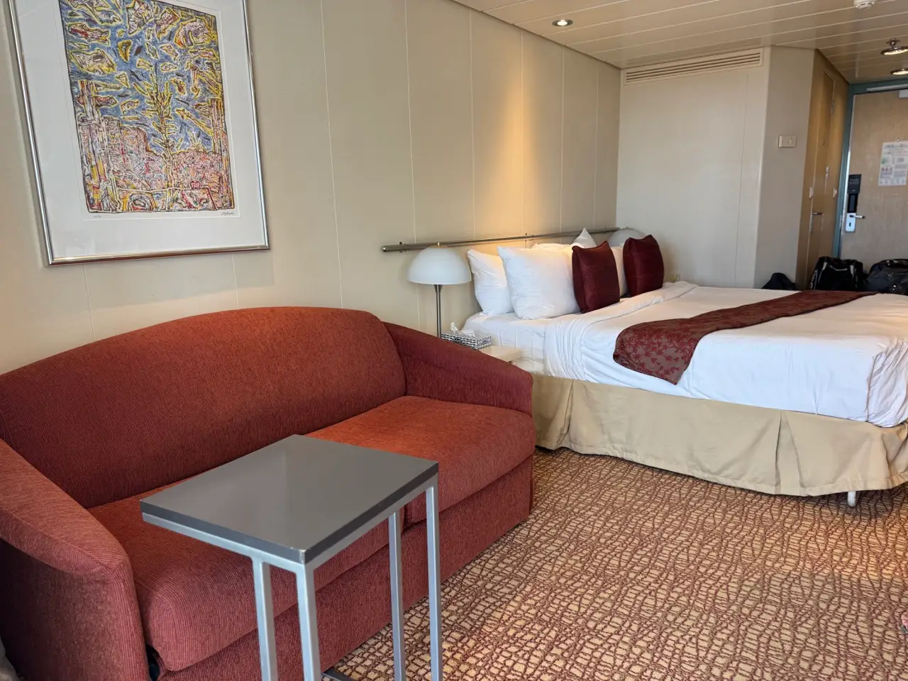 Concierge class room with full-sized couch for entertaining on Celebrity Constellation
