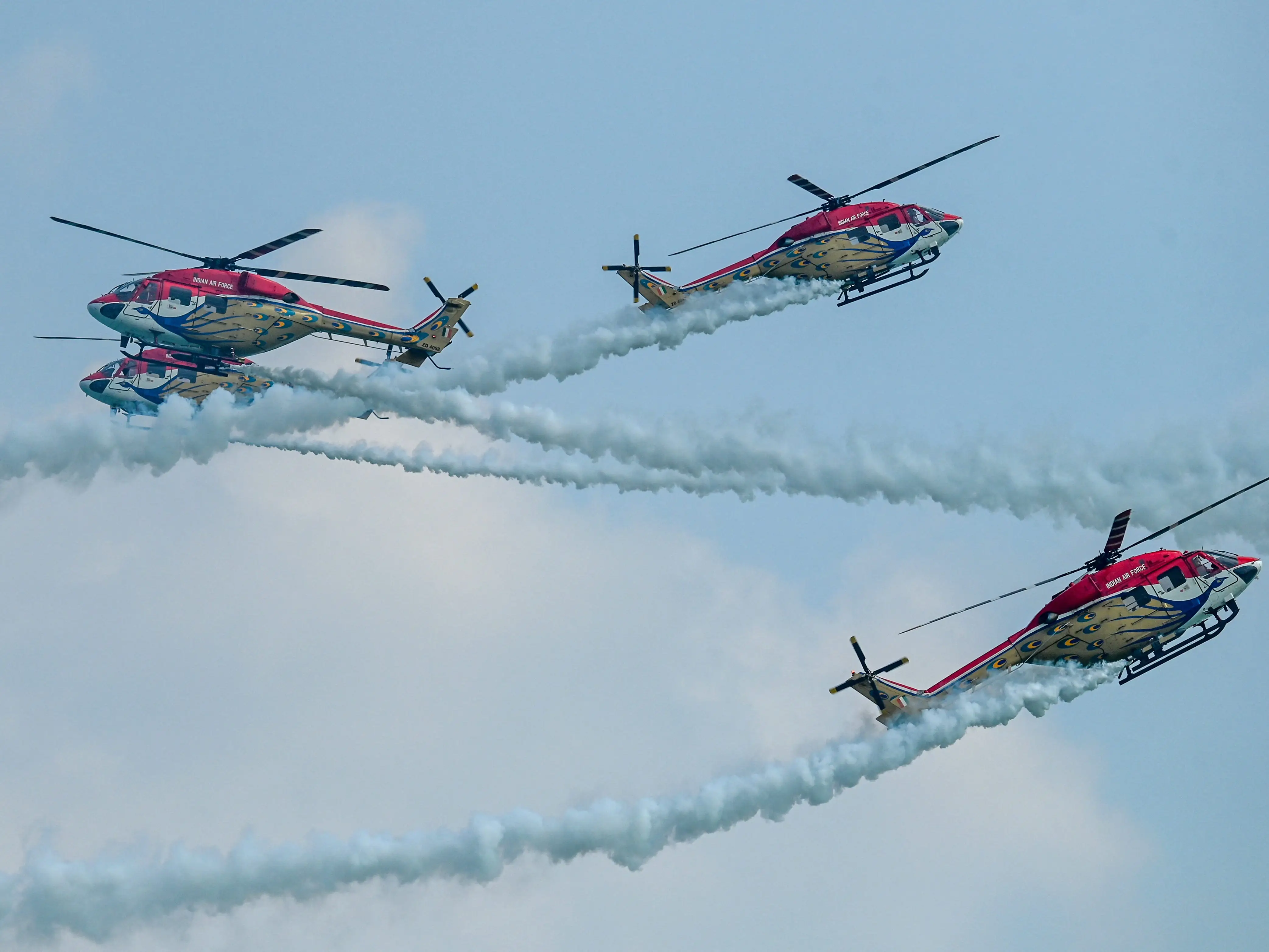 Indian Air Force's Sarang helicopter display team fly in formation during a media preview aerial display ahead of the Singapore Airshow in Singapore on February 1, 2026.