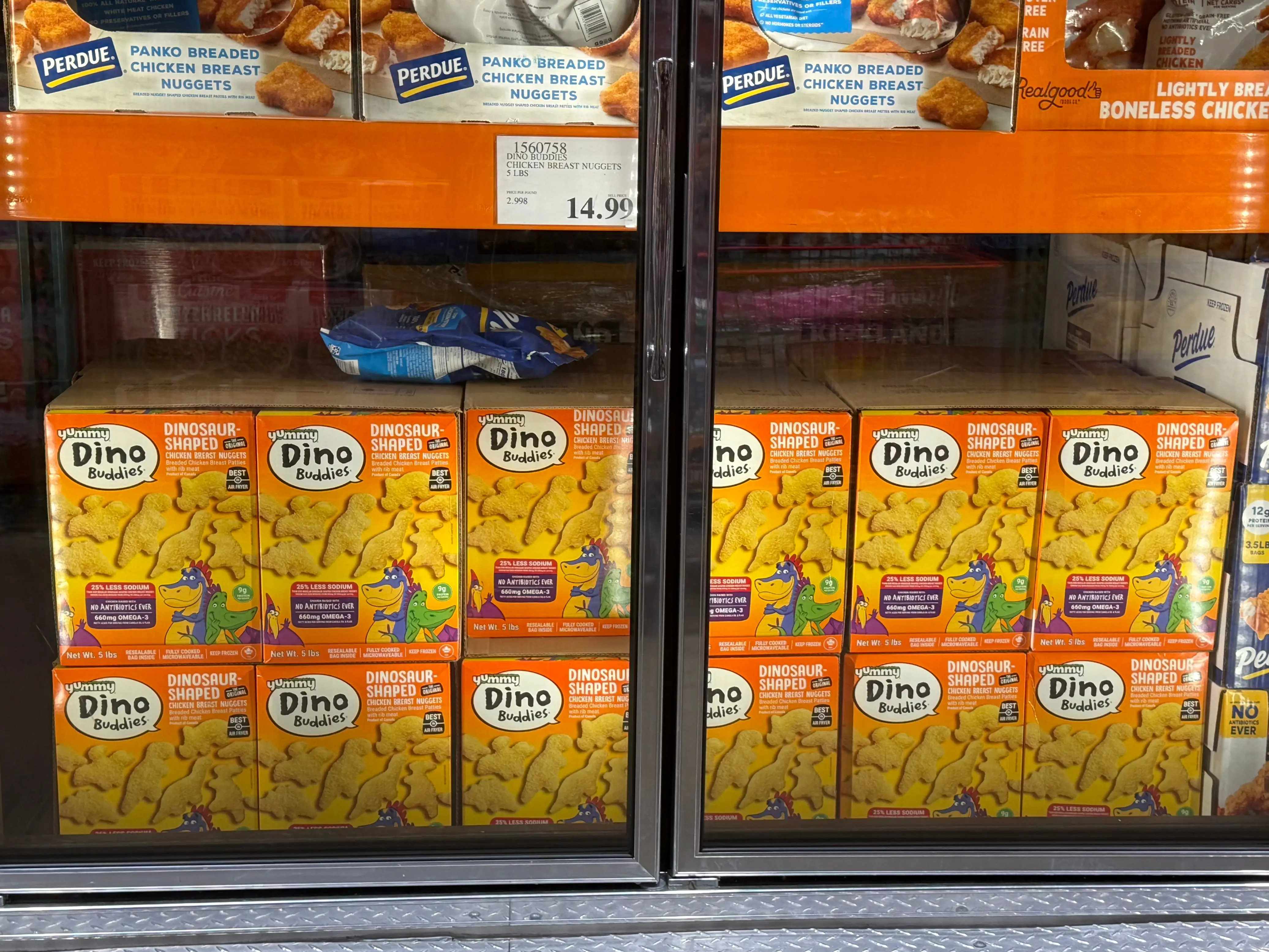Boxes of Dino Buddies nuggets in a freezer case at Costco.