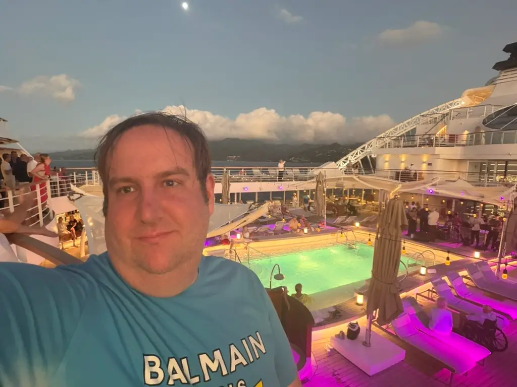 Author David Morris smiling on top deck of cruise