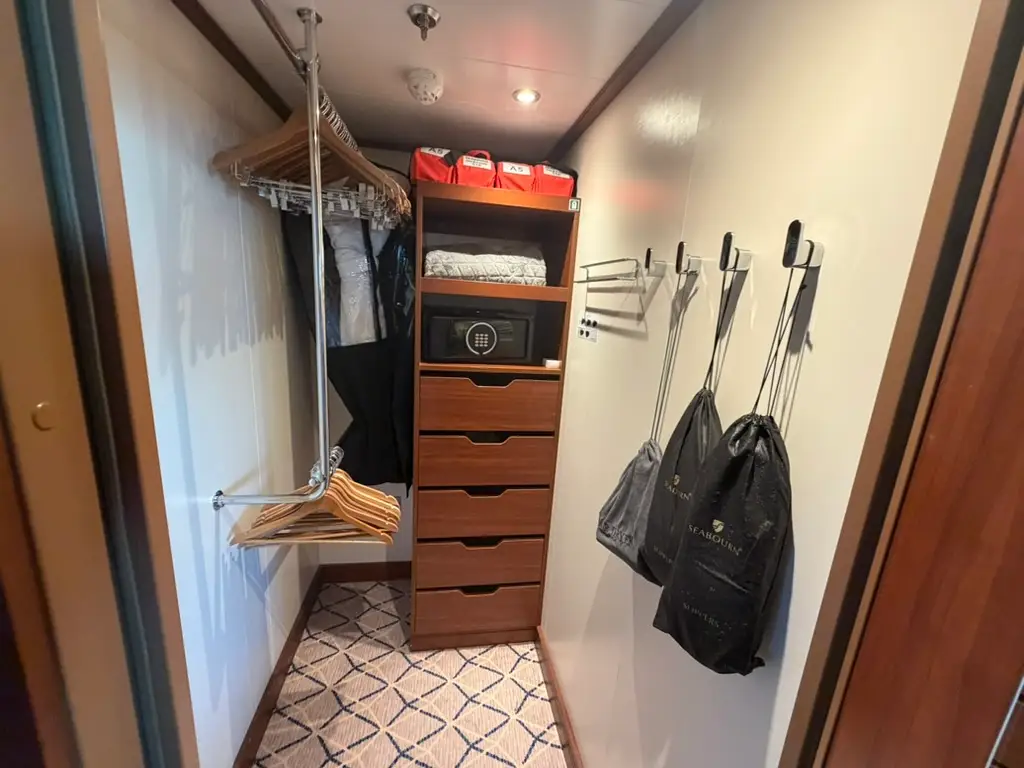 Closet with draw chest, hooks on walls