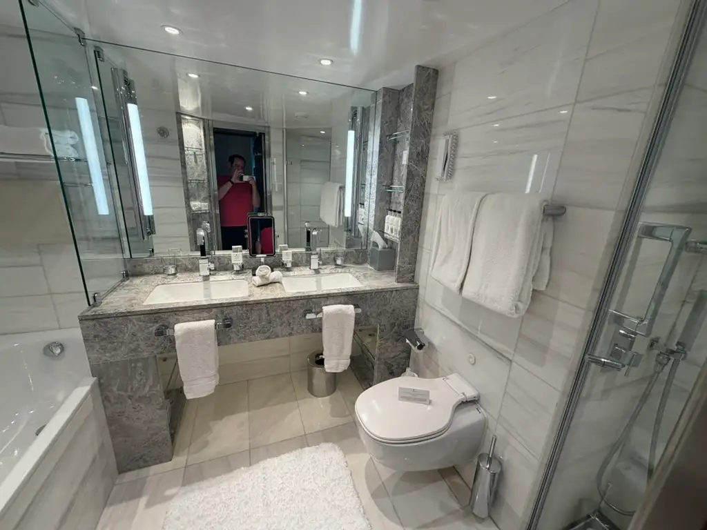 White bathroom with large mirror, counter