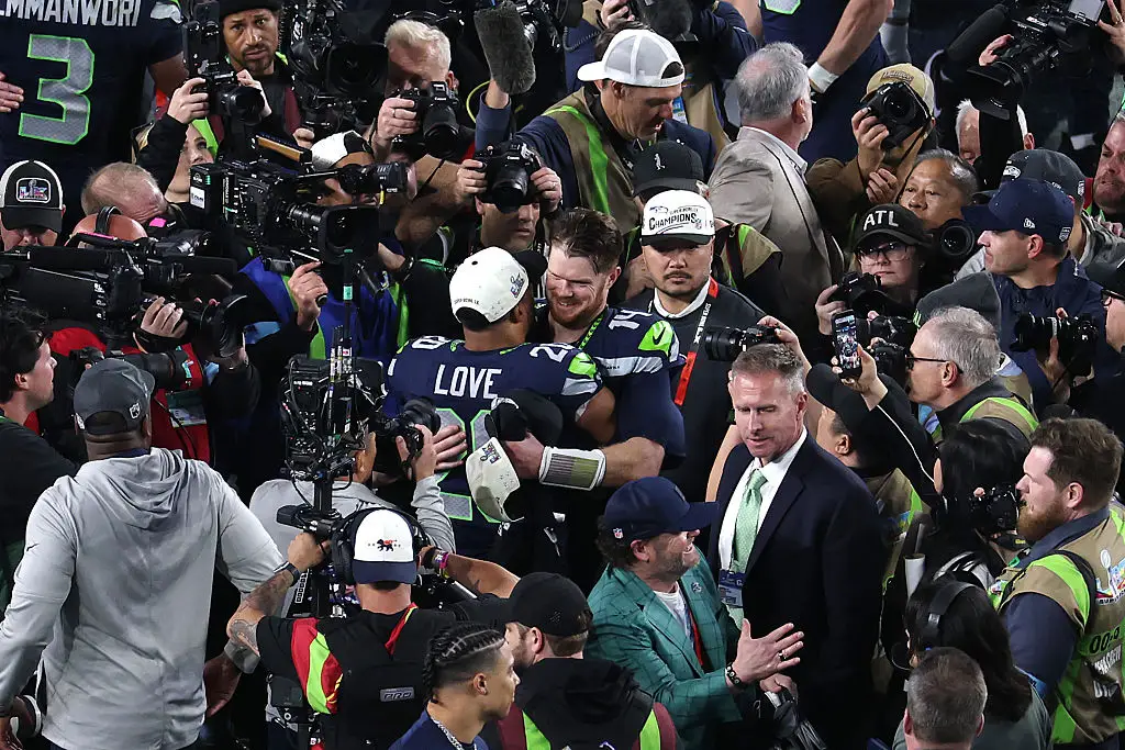 Sam Darnold and Julian Love embraced after winning Super Bowl LX.