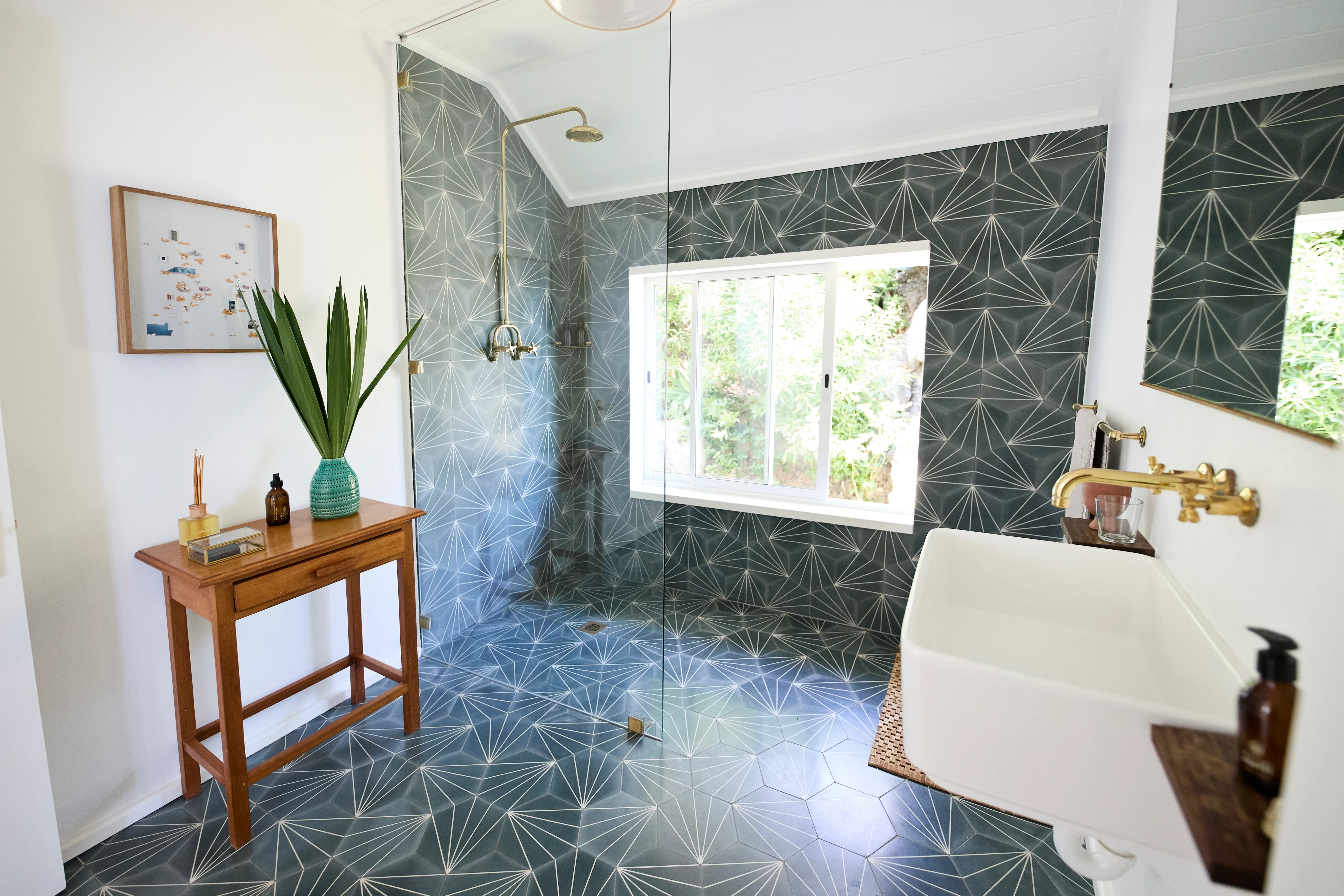 Bathroom with patterned tile in shower and on floor
