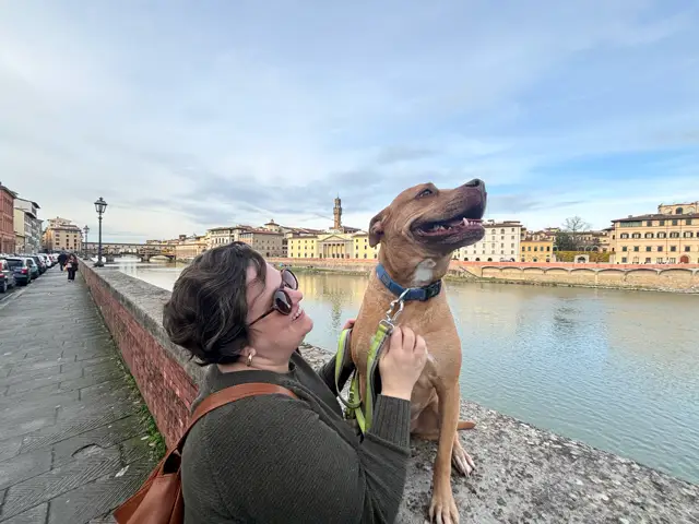 Author Katie Carson smiling with dog in Italy