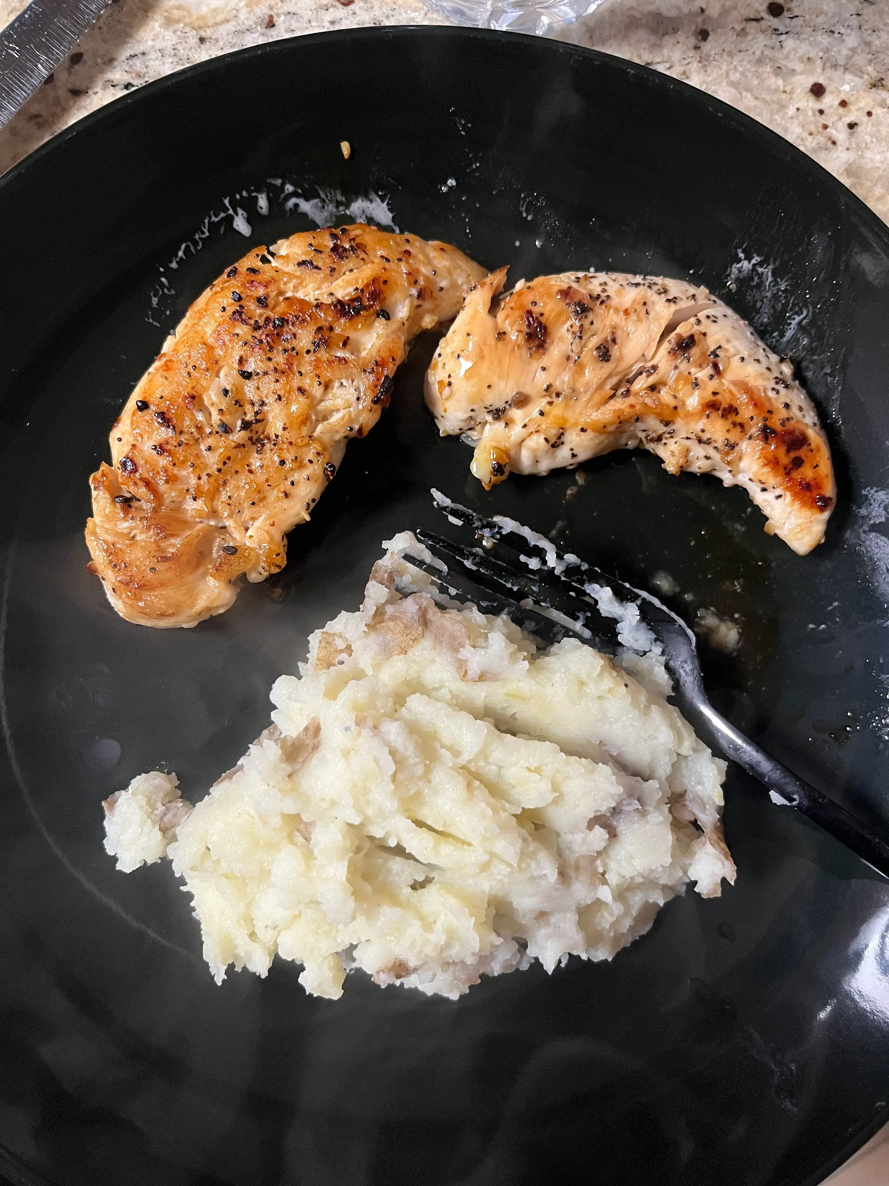 two chicken breasts and mashed potatoes