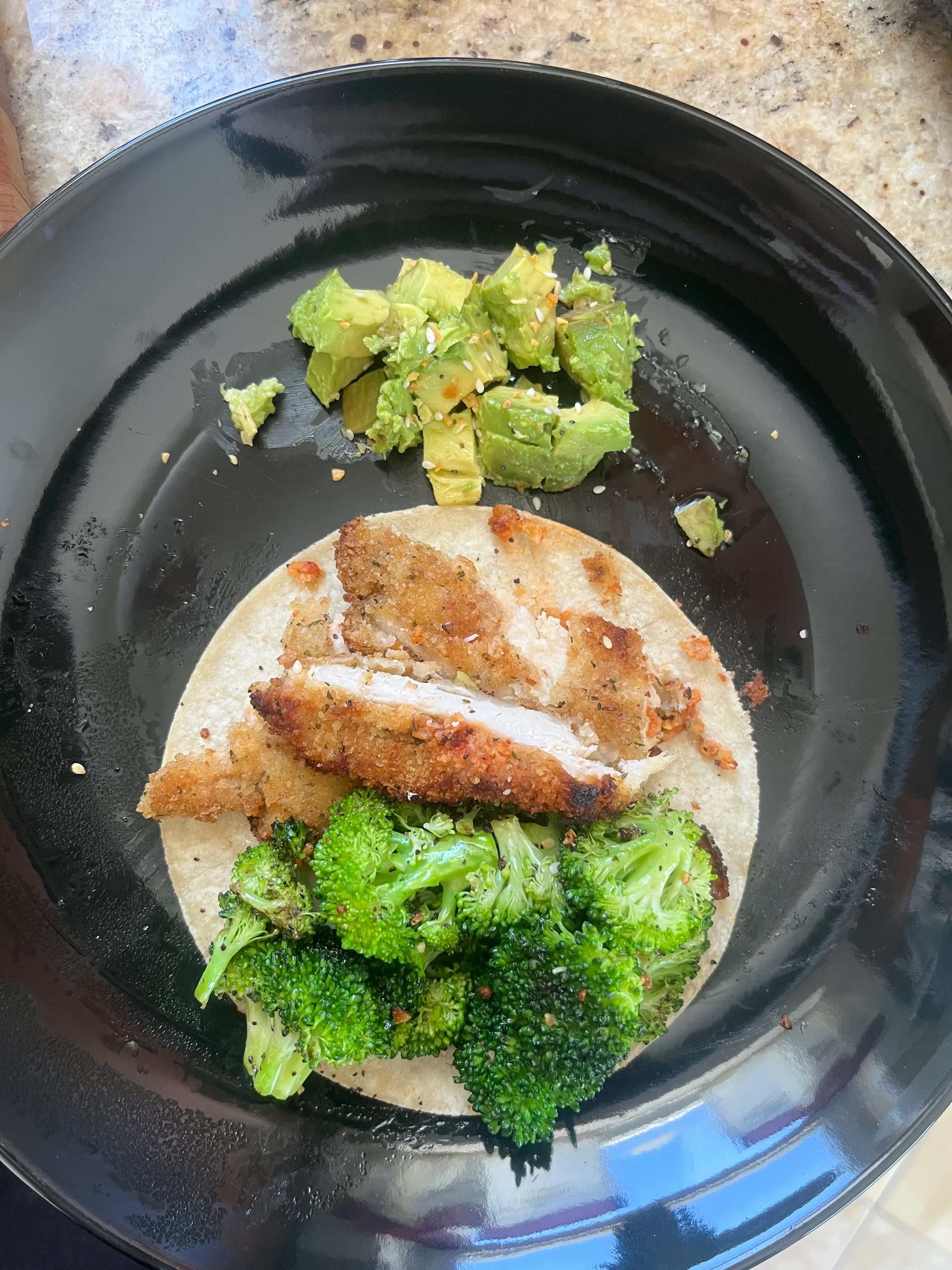 a tortilla with broccoli and chicken and avocado