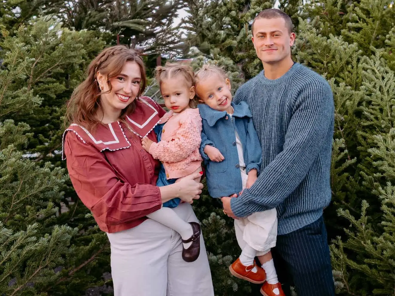 Family of four posing for photo