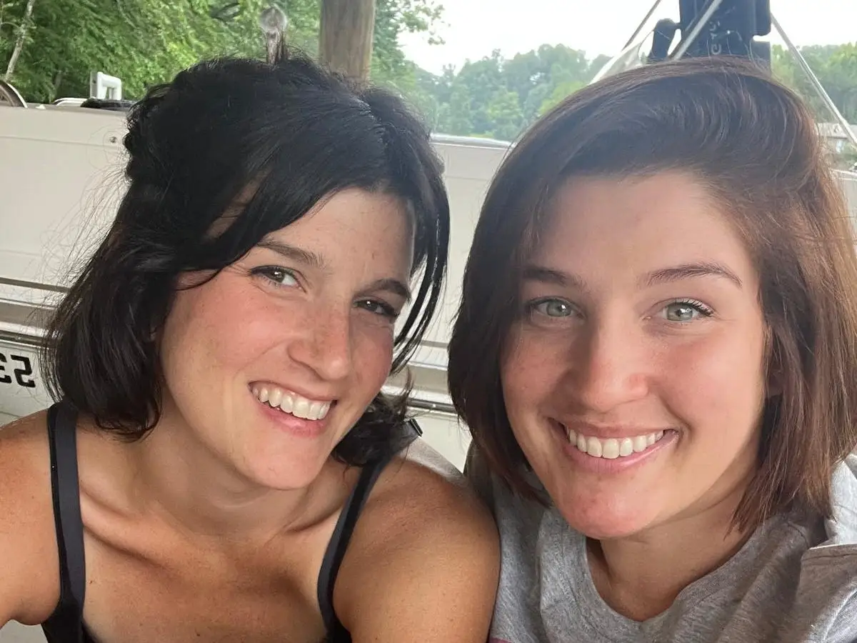 Sister posing for photo in a boat