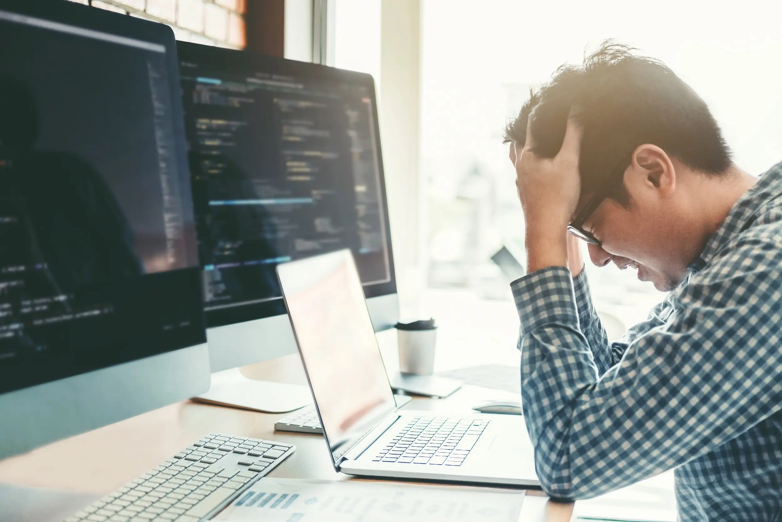 A frustrated AI programmer is shown in this stock image