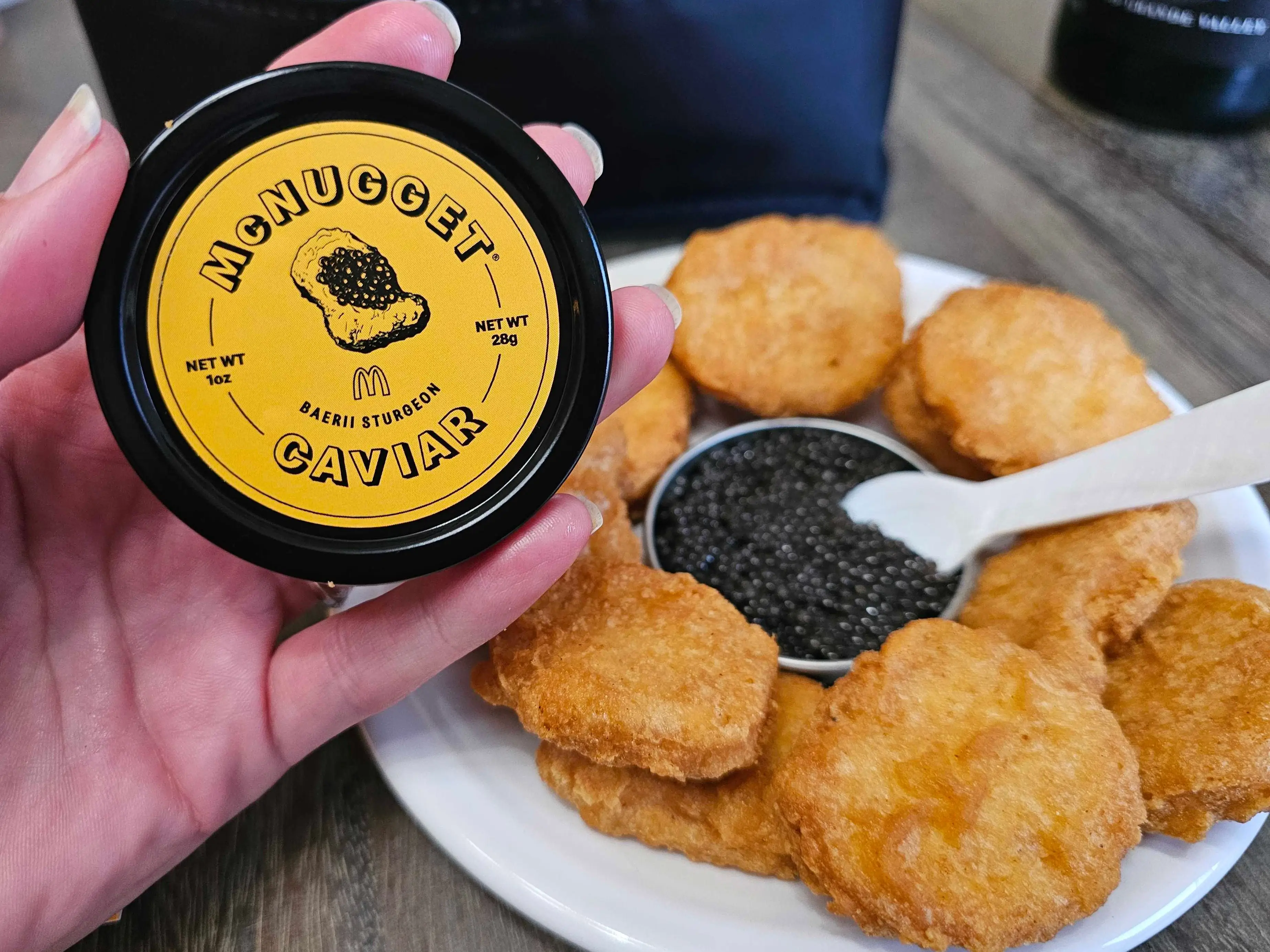 A tin of Baerii Sturgeon caviar sits at the center of a plate of McDonald's McNuggets.