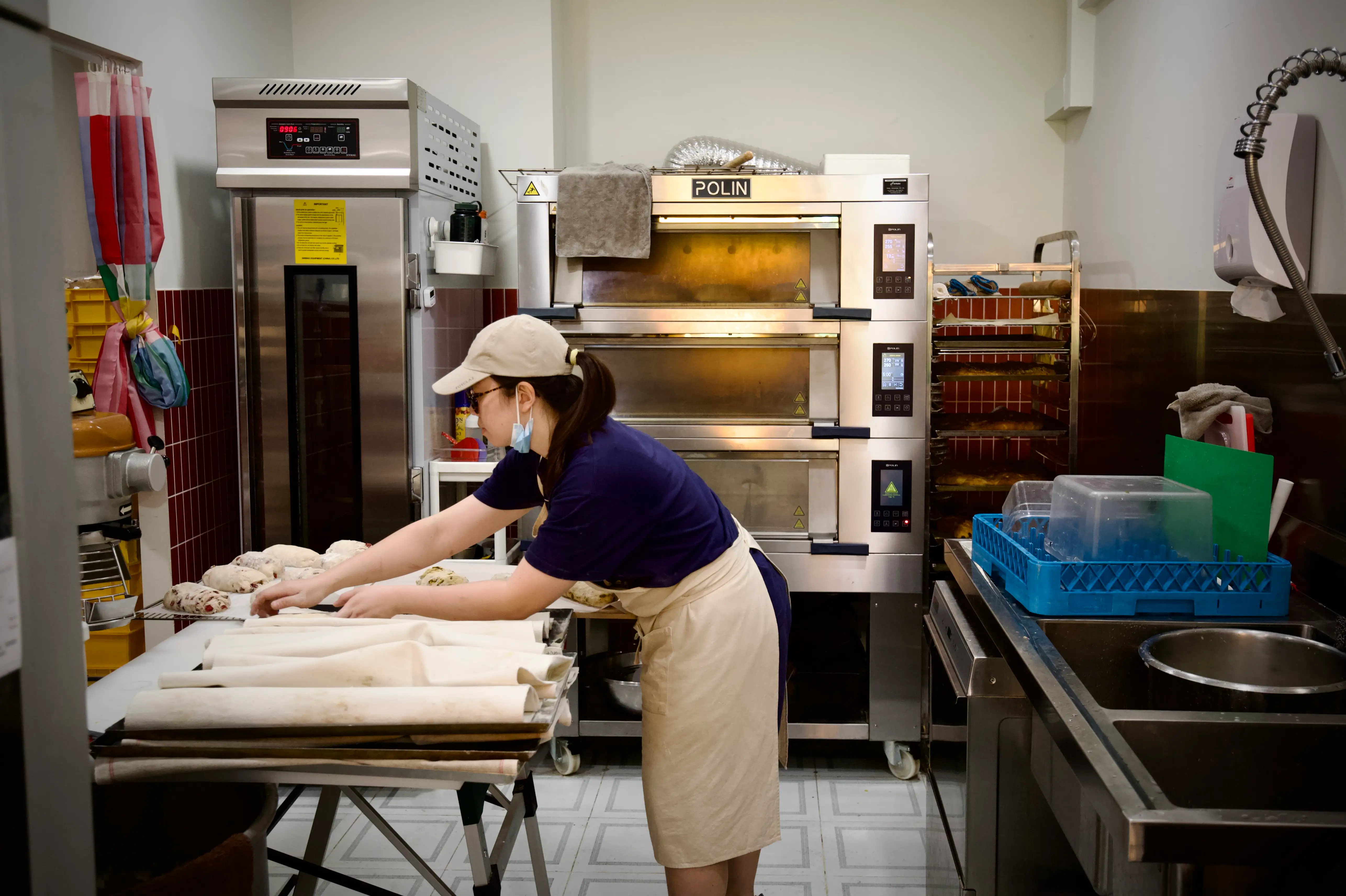Au Hui Her preps loaves of sourdough bread before opening her bakery in the morning.