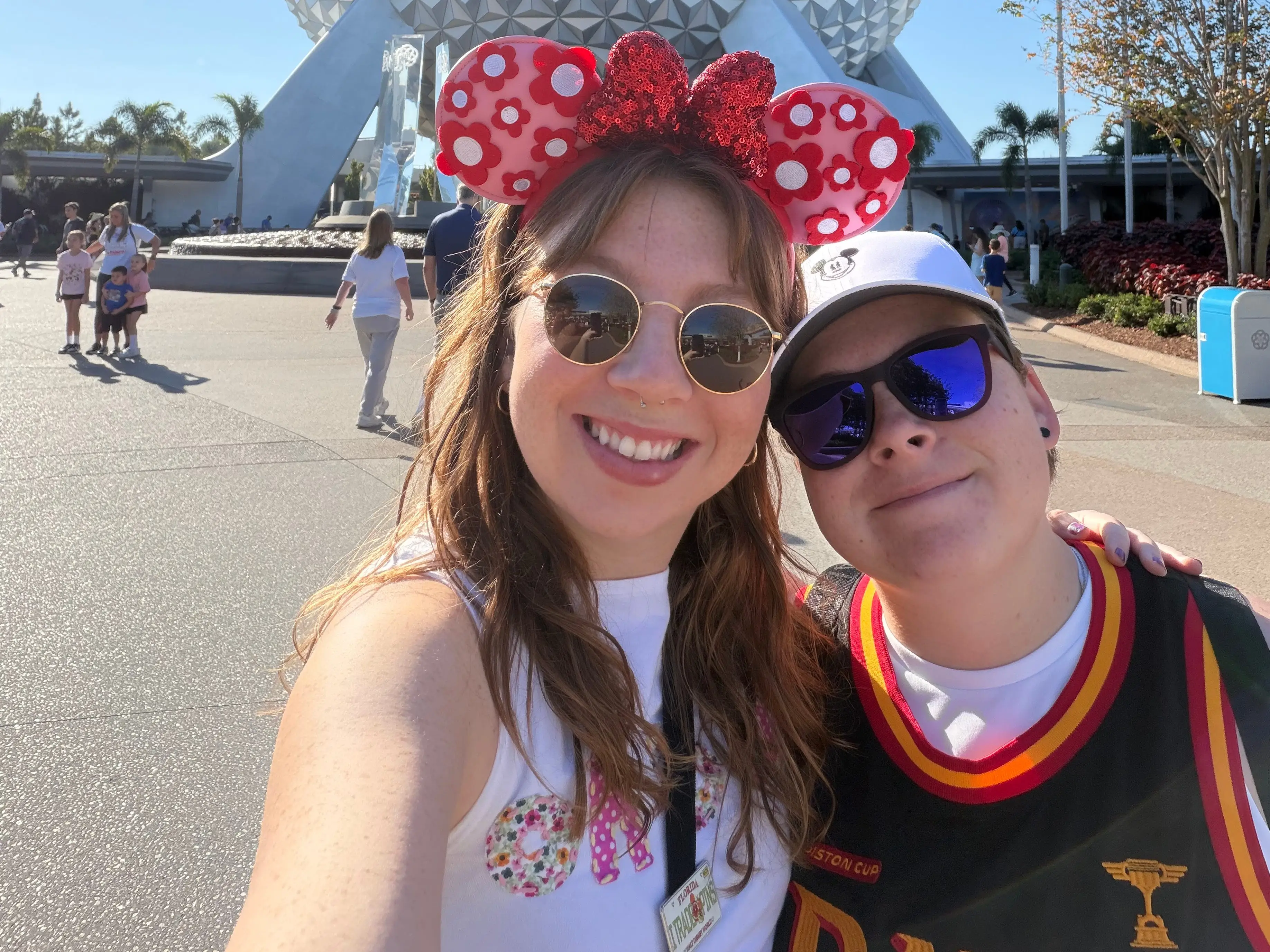 Author Jodryn Bradley and her partner smiling in front of Epcot ball